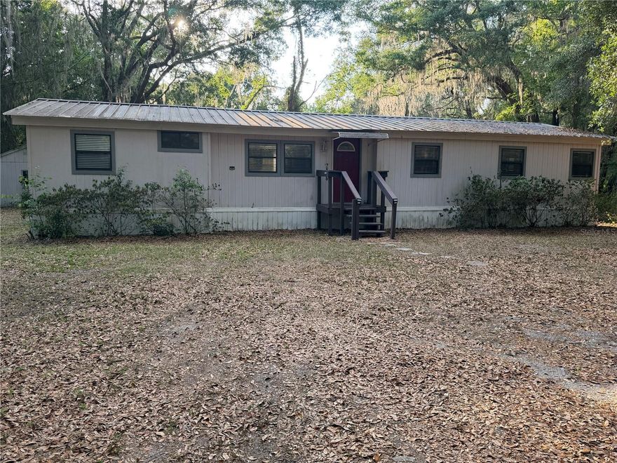 This 3-bedroom, 2-bathroom double-wide home offers a spacious 1,423 square foot layout on a cleared 1.01-acre lot. Featuring high ceilings, vinyl flooring, large laundry room, eat in kitchen, bonus room for an office, double primary bedroom and a Florida room for extra living space so as the interior provides a comfortable and modern feel. The exterior is built for durability with HardiPlank type siding and a metal roof. The lot features a large barn style shed that could be finished into a guest house, art studio, music room, etc. Property has citrus trees, mature grape vines, large live oaks for plenty of shade. 
Just minutes to 6000 acre Santa Fe with 4 public boat ramps and parks. Home is Located in Lake Bonnet Estates, you are in the heart of Florida's lake country, surrounded by numerous recreational lakes for boating, fishing, and outdoor enjoyment  Enjoy over an acre of cleared, wire-fenced land with no HOA fees or restrictions.
This property is perfectly situated in Melrose, offering a convenient commute between the city amenities of Gainesville and the historic charm of Palatka.