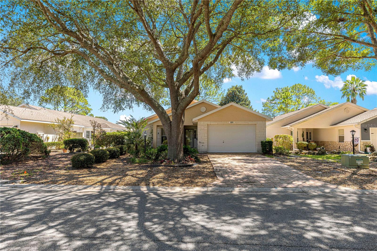 GOLF COURSE VIEW: This popular Madison Model Single-Family Courtyard Home located in the Williamsburg Neighborhood of On Top of the World, an Active Premiere Gated Golf Community and near the amenities. This home has 2 bedrooms, 2 bathrooms, and a 2-car garage, tankless water heater (2022), newer roof (2017), A/C (2024), private courtyard and is a move-in ready home. When you pull up to the brick paved driveway, walkway and covered front porch is a great spot to enjoy morning coffee. Step into the entry foyer. The Guest Bedroom and bath are to the left of the entry foyer. The guest Bedroom has a walk-in closet and the guest hall with a large linen closet, then enter the guest bathroom a long vanity with a single sink and plenty of cabinet storage, and a door leads to the combo tub/shower. Moving down the foyer is a huge great room and dining area. The Primary Bedroom is on the back left of the home for privacy with newer carpet, linen closet, walk-in closet and area for makeup/dressing area. The primary bath has a large vanity with two sinks, step-in shower with a seat, solid glass door, private area with an elongated toilet and tile flooring. Back to the Great Room is the Kitchen area with eat -in area, newer appliances, pantry, door leading to the courtyard, door leading to inside laundry room and a door to the garage. Moving back to the Great Room is French doors leading to an enclosed three season lanai which has the perfect view of the Tortoise and Hare’s second fairway. Lanai has a door leading to a “Very Private” Courtyard with gate in front. (Your neighbor does not have any windows on your courtyard) The Kitchen door leads to the courtyard for your private grilling out. Enjoy your private backyard and courtyard! On Top of the World is Ocala’s premier adult, golf course community and has a wealth of amenities while being just a golf course ride away from dining, healthcare and entertainment.