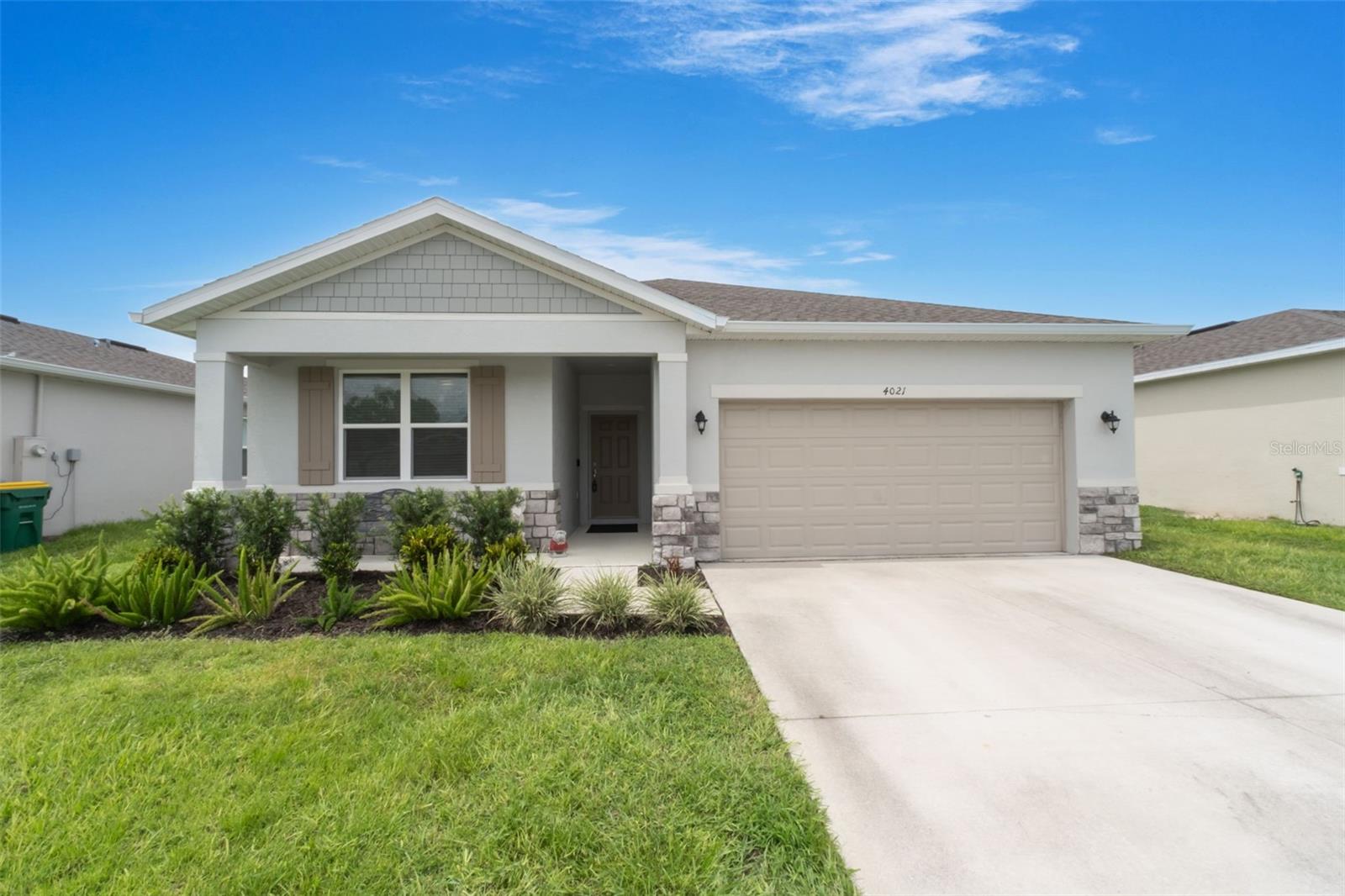 Welcome to this beautifully maintained 3-bedroom, 2-bath home in the desirable Mayhill community of Eustis—just minutes from Lake Eustis and charming Downtown Mount Dora. Built in 2022 by Stanley Martin Homes, this “Baker” floor plan was designed with efficiency, comfort, and style in mind. Since purchasing, the owners have added several valuable upgrades, including a vinyl privacy fence, full gutter system, ceiling fans in every room, and a screened-in back porch—perfect for enjoying Florida evenings year-round.
Step inside through the covered front porch into a welcoming foyer, where you’ll find two spacious bedrooms and a full bath with double vanity tucked neatly at the front of the home—ideal for guests or a home office. The heart of the home is the open-concept kitchen, living, and dining area. The kitchen features a large center island, stainless steel appliances, and plenty of cabinet space, all overlooking the bright and airy living space—perfect for entertaining or everyday living.
The private primary suite is located at the rear of the home and offers a large walk-in closet and en-suite bath with dual sink vanity. Step outside to your newly screened-in porch and fully fenced backyard—ideal for pets, play, or relaxing in peace.
Located in a growing community surrounded by nature, yet close to shopping, dining, and weekend markets in Eustis and Mount Dora, this home offers the best of both convenience and quiet living.
Don’t miss your chance to own a nearly new home with custom upgrades—schedule your showing today!