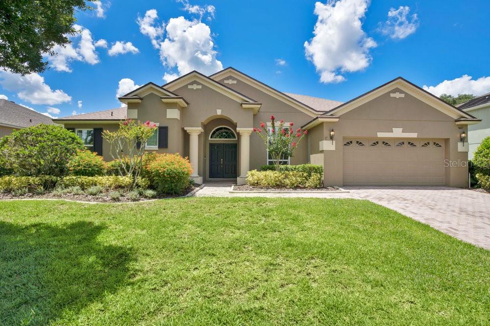 Welcome to this stunning Windermere pool home, located behind the iron gates of the desirable Westover Club community. This spacious 4-bedroom, 3-bathroom residence offers a thoughtfully designed 3-way split floor plan, perfect for both everyday living and entertaining. Private Backyard Paradise: Enjoy a serene outdoor space with an expanded paver patio, screen enclosure, a covered lanai and fully fenced backyard—ideal for relaxing or entertaining by the pool. Luxurious Primary Suite: Features a 10x9 extended flex space (perfect for an office, nursery, or sitting area), an oversized bathroom with dual vanities, garden tub, standalone shower, and a walk-in closet. Private access leads directly to the lanai and pool area. The formal living room offers direct access to the lanai, creating seamless indoor-outdoor flow. Gourmet Kitchen: Outfitted with 42” cabinetry, a central island, sleek granite countertops, and stainless steel appliances, designed with the home chef in mind. Spacious Secondary Bedrooms: Two additional bedrooms with a shared full bath are conveniently located off the kitchen. Private Guest Ensuite: Offers its own bath and direct access to the lanai, providing ideal accommodations for guests or multi-generational living. Inside Laundry Room: Includes washer and dryer for added convenience. UPGRADES: 2024 NEW ROOF, 2021 NEW WINDOWS AND DOORS, 2018 NEW HVAC. Gated Community with playground and sport courts. Minutes to Downtown Windermere, the Windermere Chain of Lakes, Dr. Phillips, and the Sand Lake dining and shopping district. Easy access to major highways, Downtown Orlando, and theme parks. This move-in-ready home offers the perfect blend of luxury, functionality, and location. Schedule your private tour today and experience everything this exceptional Windermere home has to explore.