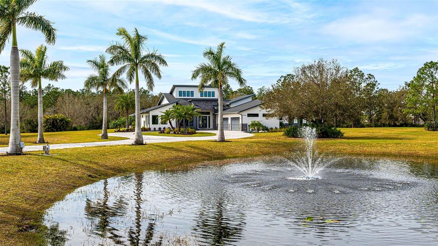 Step into the lap of luxury with this breathtaking Panther Ridge estate, where modern elegance meets the tranquility of a 10+ acre paradise. This 5-bedroom, 4.5-bath masterpiece boasts not only a 4-car garage but also a whopping 4,943 sq/ft of sheer opulence. Marvel at the grandeur of the 26' ceilings that greet you upon entering, creating a sense of space and airiness. The interior is adorned with luxurious finishes making every corner a feast for the eyes. The open floorplan seamlessly combines the family room, dining area, and kitchen into a functional living space that exudes warmth. As you explore, the owner's suite beckons with its high vaulted ceiling, large windows, and glass sliding doors that flood the room with natural light. Dual closets with custom built-ins provide ample storage, while the en suite bath is a spa-like retreat, featuring a seamless glass stand-alone shower, a separate tub, and a double vanity with custom European cabinetry and quartz countertops. The heart of the home, the kitchen, is a chef's dream come true. An oversized island with custom dual-tone cabinetry and quartz counters sets the stage for culinary adventures. Luxury stainless steel appliances, including a side-by-side refrigerator, beverage fridge, wall oven, microwave, induction range, and hood, elevate the cooking experience to new heights. The guestrooms are no less impressive, with oversized windows and en suite full bathrooms offering both comfort and style. A large bonus room, complete with high ceilings, large windows, and sliders, provides additional versatile space for entertainment or relaxation. Step outside to the resort-style pool and outdoor living areas, where a lanai with an outdoor kitchen and fireplace seating area awaits. The oversized pool with a huge spa, sun shelf, and multiple seating areas create a haven for relaxation. A gas fire pit and spacious sundeck add to the allure of the outdoor oasis. This estate is not just about luxury; it's also designed for practicality and security. With a 32kw generator, hurricane-rated windows and doors, 10 independent HVAC zones, and home automation for lights, blinds, fans, and controls via mobile device or Alexa, it seamlessly blends modern convenience with timeless elegance. Welcome home to a life of unparalleled comfort and style!