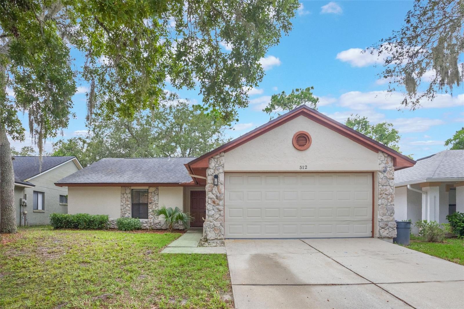 LOCATION!! Welcome to this charming 4-bedroom, 2-bathroom home in Lake Mary, home to some of the best rated public schools in Seminole County! New Roof installed in 2018. As you pull into the driveway, you'll notice the nice exterior curb appeal with the aesthetic brick trim on the garage and front window for added charm. As you enter property, you'll notice the laminate and tile flooring all throughout, no carpets! The split floor plan flows very well for a smaller 4 bedroom. To the left front of the home, you'll have 3 guest bedrooms sharing a full guest bathroom. And towards the back left side of the home past the open living room, you'll find the spacious master bedroom with an en-suite master bathroom. It is fully equipped with both an upgraded freestanding shower with nice tiled aesthetics, a separate tub, and dual separated vanities for added convenience. The kitchen is spacious and open including stainless steel appliances, and plenty of cabinet and prep space to explore your inner chef and host for guests. Other convenient notable features include ceiling fans throughout for added air circulation, light fixtures in the formal dining room, a cute fireplace in the living room overlooking the spacious fully FENCED backyard through the glass sliding doors that has a nice fire pit for roasting marshmallows and family time stories. You also have your own laundry room inside the home next to the 2 car garage. This location is perfect, especially for families with the highly rated Seminole county schools zoned for Lake Mary Elementary, Greenwood Middle, and Lake Mary High with walking distance. Also, close access to the new Orlando Health, hospitals/clinics, shopping, dining, parks, and major highways including Lake Mary Boulevard, I-4, and 417. Easy access towards downtown Orlando, the Orlando International Airport, and the Seminole Bike Trail. This home is ideal for families seeking the best education for children. Don’t miss the opportunity to make this property YOUR home, schedule your private tour Today!!