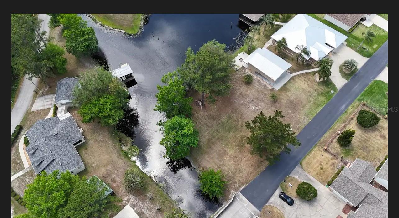 Featuring a unique corner location, this canal front lot spans approximately 80 x 125 +/-, with canal access along the back and eastern sides. Legal records confirm that the property's boundaries extend into both canals. The lot provides direct access to the St. Johns River, allowing for exploration of its 300-mile length, including popular spots like Jax, Silver Springs, and Wekiwa Springs. Ram Island is an exclusive single-family home subdivision. Buyers have the freedom to choose their preferred builder and submit custom plans to Volusia County. The property also permits the construction of a dock, boat lift, and boathouse.