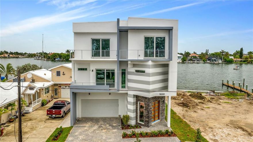 NEW BUILD AVAILABLE NOW! Situated on the deep water of Boca Ciega Bay on Treasure Island, Fl. This brand new 4,100 square feet home with elevator is fully customized to make living on the best white sand beach in the country a magical and deeply satisfying experience. With the new dock, putting your favorite vessel in the water is simple and easy. The newly built seawall ensures your view and access to the water, as well as the lifestyle that accompanies it, is protected. Built in a sleek and modern architectural style. The spacious open floor plan lends itself to entertaining. With its abundance of windows throughout, you'll enjoy unparalleled views and a bright airness inside. Floor-to-ceiling windows also allow you to look out to the sun decks and pool. When you aren't out on the water or enjoying the wide white sand beach, this area is perfect for hosting guests. A four car attached garage provides you with plenty of space to keep your vehicles protected. There is also plenty of room for you to organize your water gear neatly, so it is always ready when you are! Call today for more info on this brand new build.
--