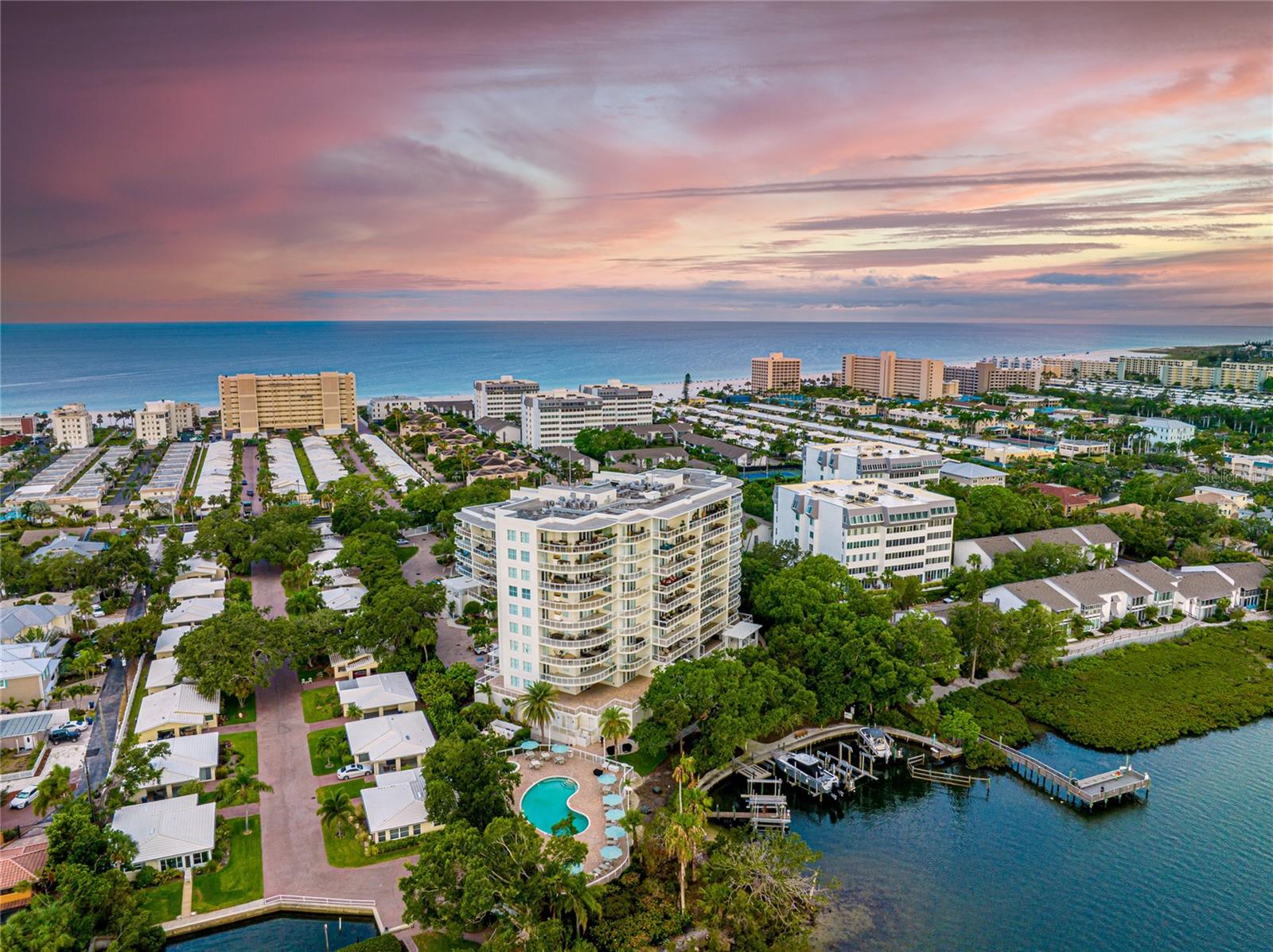 Welcome to paradise found at Summer Cove. Nestled along the pristine Gulf Coast island of Siesta Key, this exquisite condominium at Summer Cove is a true gem of coastal living, boasting the perfect fusion of modern elegance and laid-back charm. The moment your private elevator opens up directly to the foyer of your unit, you'll know this home exudes elegance and sophistication. Step inside to discover a thoughtfully designed open floor plan flooded with natural light with panoramic windows and high-end finishes. The gourmet kitchen is a chef's dream, equipped with marble countertops, top-of-the-line appliances, custom cabinetry, and a spacious center island – perfect for culinary creations and entertaining guests. You will love the layout of this condo that truly lives like a single-family home, with each of the three bedrooms boasting its own en-suite bathroom and walk-in closets for ultimate comfort and convenience. The owner's suite is privately situated on the condo's east wing, characterized by its large spa-like bathroom with custom cabinetry and his and hers walk-in closets with built-ins. It does not end there, as this unit has a grand terrace unlike any other on Siesta Key. This outdoor oasis provides the perfect setting for alfresco gatherings, starlit soirees, and lazy afternoons lounging under the sun overlooking the sparkling pool and the ever-changing hues of the Intracoastal waters. In addition, Summer Cove is one of the premier amenity-rich communities on Siesta Key. You can stay active and fit with a state-of-the-art fitness center and enjoy social gatherings at the clubhouse and community events. You can also rest easy knowing this gated community offers security and privacy for peace of mind. This is a once-in-a-lifetime opportunity to own a condo that redefines luxury and offers an unparalleled outdoor experience. Don't miss out on this unique gem – schedule your exclusive tour of this extraordinary unit at Summer Cove on Siesta Key today!