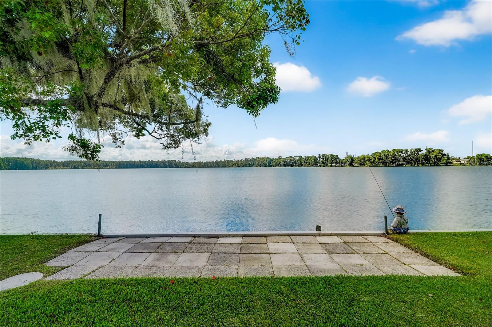 Lakefront home for sale on beautiful Trout Lake in Eustis FL with amazing panoramic lake views! Affordable living right on a beautiful sports and fishing lake with 65 feet of lake frontage in the desirable Country Club Manor, a co-op 55+ community with great amenities like- clubhouse- shuffleboard- swimming pool and more! Water, trash and sewer are also included in the $231. monthly co-op fee. 2 bedrooms and 2 full baths, 1,104 Sq Ft and total square feet under air along with a very large screened in patio area with lake views, giving a total covered area of 1790 square feet. The family/dining rooms plus the screened patio/lanai overlook the lake. Open floor plan with Kitchen, living room & family room combination. Community boat ramp, heated lakefront POOL and fishing pier. Only minutes to downtown Eustis with great restaurants and shopping and Mt. Dora is just a short drive. This gem would make a perfect place for snowbirds or year round living in Central Florida. Make plans to tour this lovely lakefront home today!