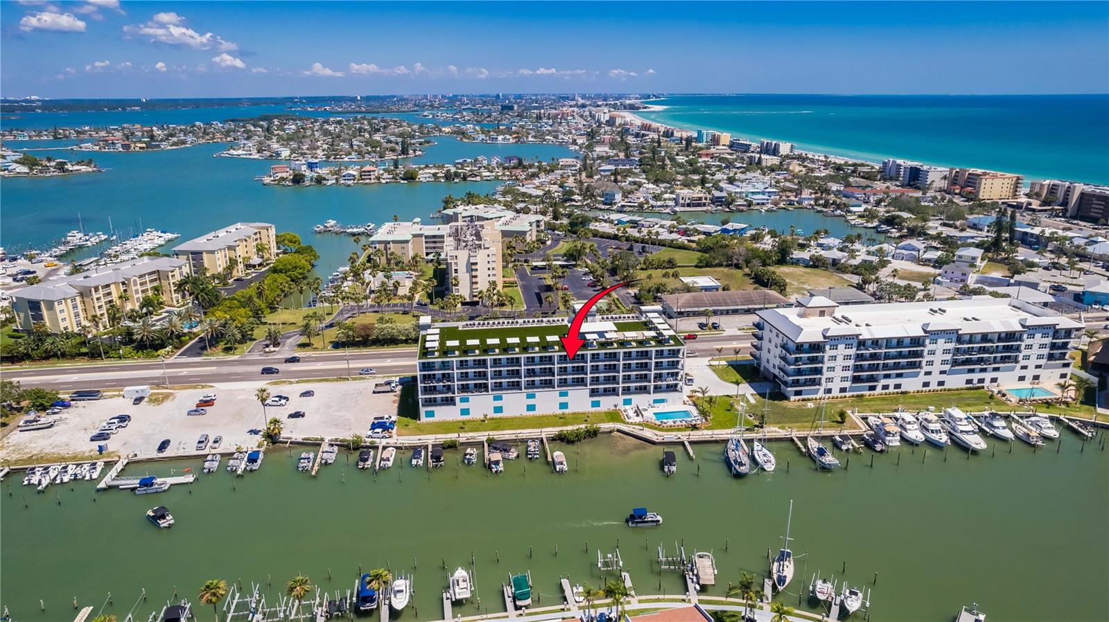 Discover your coastal escape at the Residences at Town Center on Madeira Beach. This is the only top-floor unit currently available in this exclusive, new waterfront community — furnished and move-in ready. Indulge in the pinnacle of waterfront living with this spacious three-bedroom, three-bathroom (all en-suite) residence offering unmatched luxury and sweeping water views. The open-concept design features 10-foot ceilings and luxury vinyl plank flooring throughout. You will love the double-door entry that welcomes you into a beautiful foyer. The kitchen is sure to impress with sleek Quartz countertops, solid wood cabinetry, and premium GE Café appliance package—ideal for both everyday living and entertaining. The expansive living area flows seamlessly onto a 28-foot private balcony, where you can enjoy alfresco dining or simply relax while watching spectacular sunsets over the water. Perched on the top floor, this fifth-floor condo offers sweeping, unobstructed views that simply can’t be matched by lower-level units. This boutique community of just 27 residences offers peace of mind with high-impact hurricane-rated glass doors and windows, along with exceptional amenities. Take in the 360 degree views of the gulf beaches, downtown St. Pete, and beyond from the rooftop terrace, or unwind in one of the private rooftop cabanas. Located just one block from the beach, you’ll have everything you need for the ultimate coastal lifestyle. Community features include a heated pool and spa, mature tropical landscaping, community room with balcony and full kitchen, state-of the art, well-equipped fitness room on-site, and a marina. For added security and convenience, this unit comes with two private, under-building parking spaces behind a security gate. The Residences warmly welcomes up to two pets with no size restrictions. Dog parks and dog-friendly establishments nearby. 30 Day minimum rentals allowed. Schedule your private showing today and experience luxury waterfront living at its finest.