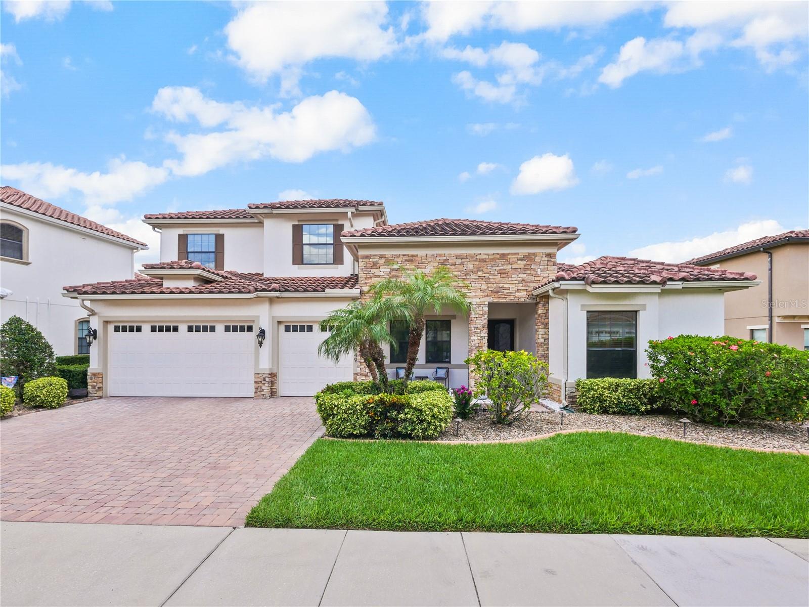 This stunning five-bedroom, four-bathroom pool home is located in the highly sought-after, double-gated estate section of Eagle Creek, offering the ultimate in privacy and luxury living. As you step inside, you’ll be greeted by beautiful dark hardwood flooring that flows seamlessly throughout the living spaces and master bedroom. The expansive main level features a formal living room, a dining room perfect for entertaining, and a spacious family room that opens to the impressive kitchen. Designed for both everyday living and gatherings, the kitchen is equipped with granite countertops, upgraded cabinetry, in-cabinet lighting, a gas stove, and generous storage.
The downstairs master suite is a true retreat with its spa-like ensuite bathroom featuring a soaking tub and a separate glass step-in shower, dual vanities, and his-and-hers custom closets. Also on the main level is an additional bedroom with access to a full pool bath, making it an ideal space for guests or an in-law suite. Upstairs, you’ll find a versatile loft and three more bedrooms, including one with its own ensuite bathroom and two that share a separate bathroom. Hardwood flooring continues upstairs, creating a low-maintenance, yet luxury feel. There is no carpet anywhere in this home!
Step outside to experience one of the largest lots in Eagle Creek, set on a tranquil pond with picturesque water views. The Mickey Mouse-shaped pool with a hot tub adds a touch of whimsy and fun to the outdoor living space, which is fully paved and includes a gas fire pit and a mini summer kitchen with a built-in gas grill—perfect for year-round entertaining.
This home has been thoughtfully updated with recessed lighting in every room, upgraded doors and windows, wiring for security and alarm systems, a hybrid 80-gallon hot water heater, and many custom closets throughout. The garage features custom flooring, and the top-of-the-line AC system is only a year old. The washer and dryer are included, making this home move-in ready.
Eagle Creek is a prestigious, 24-hour man-guarded master golf community known for its award-winning 4.5-star championship golf course, clubhouse with a pro shop, lounge, and restaurant. Residents enjoy resort-style amenities, including tennis and basketball courts, multipurpose ball fields, playgrounds, a dog park, pools, and a fitness center. Families will appreciate zoning to A-rated Lake Nona schools and the convenience of having an excellent elementary school within the community.
The location is unbeatable, just minutes from Medical City, Nemours Children’s Hospital, top-rated restaurants like Boxi Park, shopping, and major highways including 417 and 528, providing easy access to Orlando International Airport, theme parks, and the beaches. This is a rare opportunity to own an extraordinary home that perfectly combines luxury, comfort, and convenience in one of Orlando’s most desirable neighborhoods.