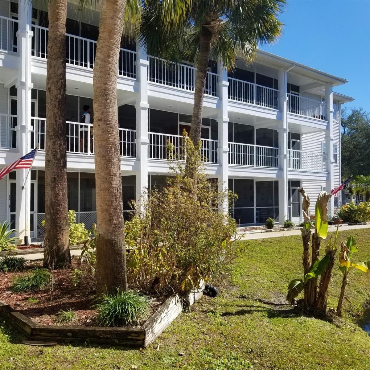 Coveted 1-Bed/1-Bath furnished condo located in Phase 3 of the gated, nudist/clothing-optional community of Paradise Lakes. Kitchen features range, dishwasher, disposal, counter microwave, and refrigerator. Built-in dry bar with glass shelves and mirror back wall is ideal for entertaining. Neutral colors and wood laminate/carpet/tile flooring. The floorplan features an eating space with table and chairs, and living room with comfy furnishings, queen sofa bed, and mirror accent wall. The primary bedroom has a king bed, dresser, nightstand, and wall-to-wall closet with sliding mirror doors. Full bath with tub-shower combination. Stack washer/dryer included for convenience. AC is dated 2017. Enjoy outdoor living in the screened covered lanai with water views. The building has an elevator for easy access. Existing furnishings, decor, and appliances included. Located close to resort amenities. Ideal for owner or investor with great rental history. Buyer is responsible for verifying all information, details, and dimensions. Condo association approval of Buyer is required including application, fee, and background check. Optional membership to Paradise Lakes Resort and amenities is not included in the monthly condo association fee.