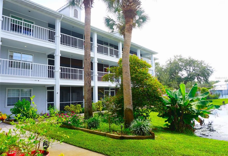 Coveted 1-Bed/1-Bath furnished condo located in Phase 3 of the gated, nudist/clothing-optional community of Paradise Lakes. Kitchen features range, dishwasher, disposal, counter microwave, and refrigerator. Built-in dry bar with glass shelves and mirror back wall is ideal for entertaining. Neutral colors and wood laminate/carpet/tile flooring. The floorplan features an eating space with table and chairs, and living room with comfy furnishings, queen sofa bed, and mirror accent wall. The primary bedroom has a king bed, dresser, nightstand, and wall-to-wall closet with sliding mirror doors. Full bath with tub-shower combination. Stack washer/dryer included for convenience. New AC installed in October 2025. Enjoy outdoor living in the screened covered lanai with water views. The building has an elevator for easy access. Existing furnishings, decor, and appliances included. Located close to resort amenities. Ideal for owner or investor with great rental history. Buyer is responsible for verifying all information, details, and dimensions. Condo association approval of Buyer is required including application, fee, and background check. Optional membership to Paradise Lakes Resort and amenities is not included in the monthly condo association fee.