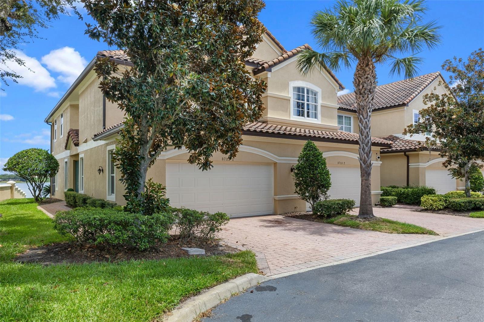 One or more photo(s) has been virtually staged. Welcome to this exceptional lakefront end-unit townhome, offering peaceful water views, modern upgrades, and unmatched convenience — all within one of Central Florida’s most desirable guard-gated communities in Dr Phillips.
Spanning over 2,500 square feet, this beautifully maintained 3-bedroom, 2.5-bathroom home features travertine flooring throughout the main level, hardwood floors upstairs, plantation shutters, and custom California closets for an elevated living experience.
Enjoy serene lake views from your private porch — perfect for morning coffee or evening relaxation. Upstairs, the primary suite includes its own lakefront balcony, creating the ultimate private retreat.
This community offers true resort-style living, with two swimming pools, two tennis/pickleball courts, two clubhouses, a state-of-the-art gym, and a brand-new playground. The HOA covers all exterior maintenance, including the roof, landscaping, and more — allowing for a truly low-maintenance lifestyle.
Located just minutes from Restaurant Row, top-rated schools, world-class shopping, the airport, and Orlando’s famous theme parks, this townhome offers the perfect balance of luxury, comfort, and location.
Monthly fees include all the community amenities, cable TV & Internet. Don’t miss this rare opportunity to own a move-in-ready lakefront townhouse in Orlando.