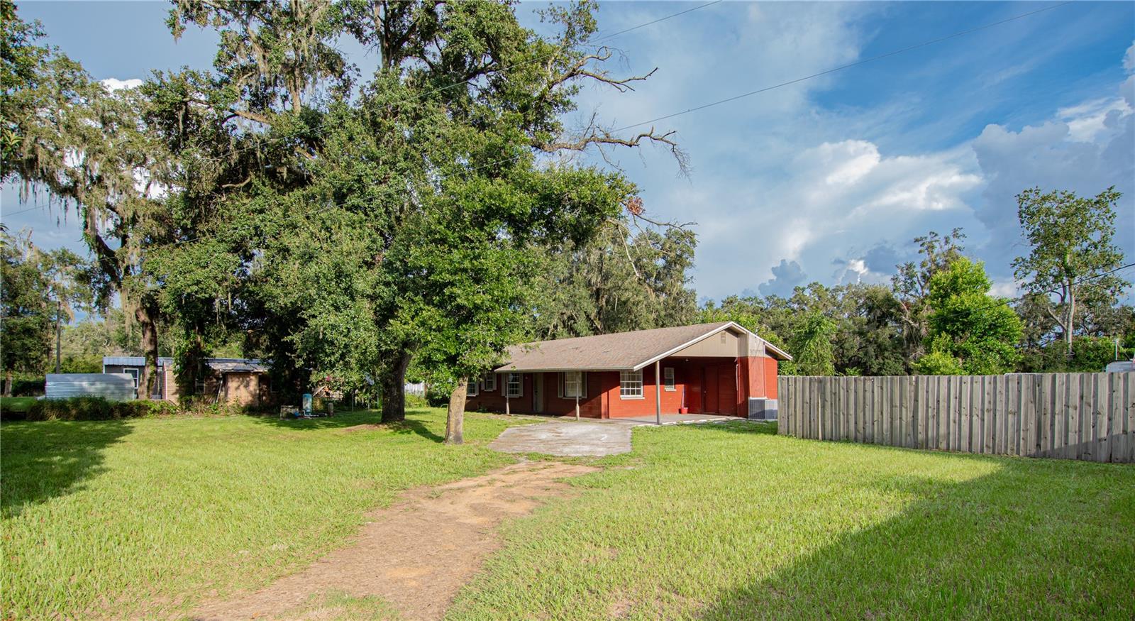 Spacious 4-Bed Block Home on Double Lot!
Enjoy the best of Zephyrhills living in this solid block 4-bedroom, 1.5-bath home. Freshly painted inside and out, it features tile flooring and ceiling fans throughout. Relax on the charming front porch or take advantage of the convenience of the attached carport. Major updates include a newer roof and A/C for worry-free living. Sitting on two lots, this property offers plenty of space for outdoor living, pets, or future possibilities—all in a quiet neighborhood just minutes from town!