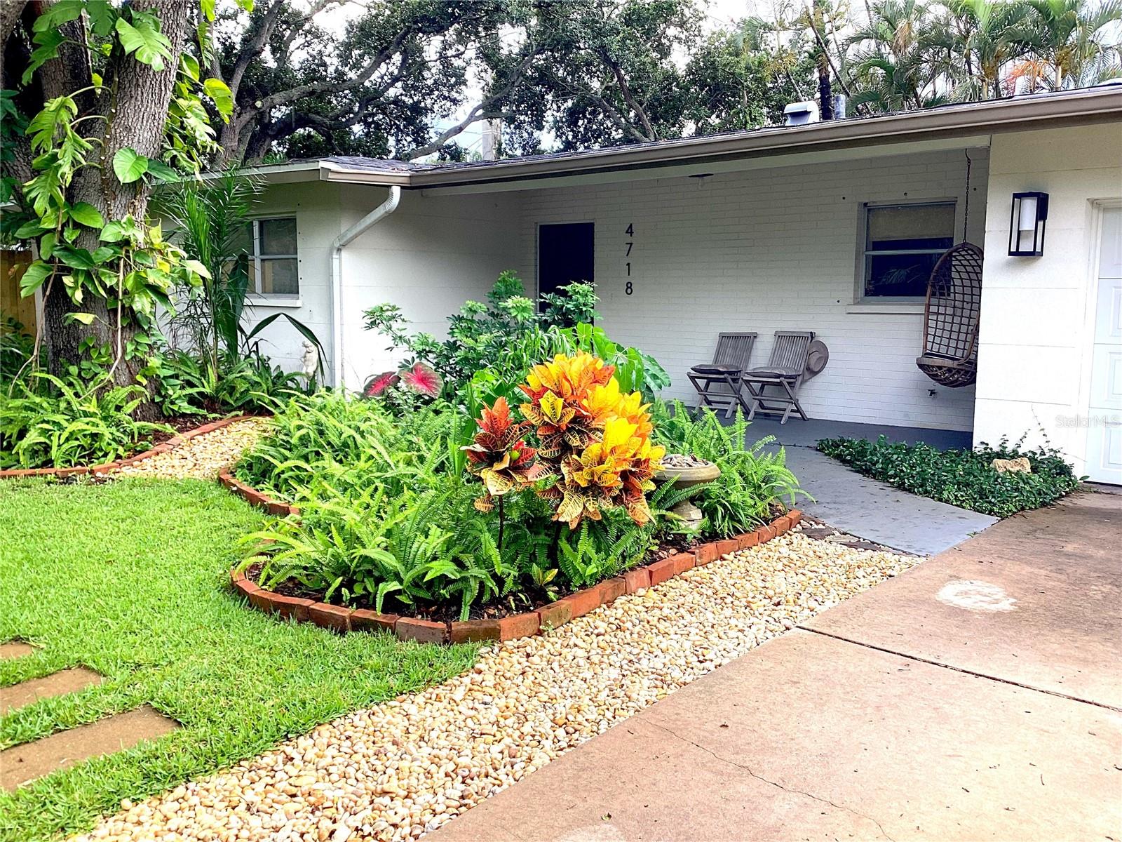 This Florida bungalow's feng shui is unmatched! Thoughtfully renovated with a modern/coastal vibe and mid-century terrazzo flooring, the newly remodeled kitchen features a farmhouse sink, shaker cabinets, and new stainless steel appliances with an open floor plan to the dining and lounge area. The adjacent Florida room is bathed in natural lighting with a wall of windows that look on to the garden! Renovated bathrooms feature brass hardware, slate floors and subway tile for a clean, modern sensibility. Property is immaculately landscaped, enveloped in lush foliage that fully surrounds the house, and planted with Florida natives for an exotic feel while also allowing for easy maintenance. Stone pathways and wrought iron gates provide a pleasing, oasis-like aesthetic. Located in the highly rated school zones for Phillippi Shores Elementary School and Riverview High School, and just fifteen minutes to Siesta Key beach, as well as close proximity to Trader Joes and Sarasota Medical Center.
