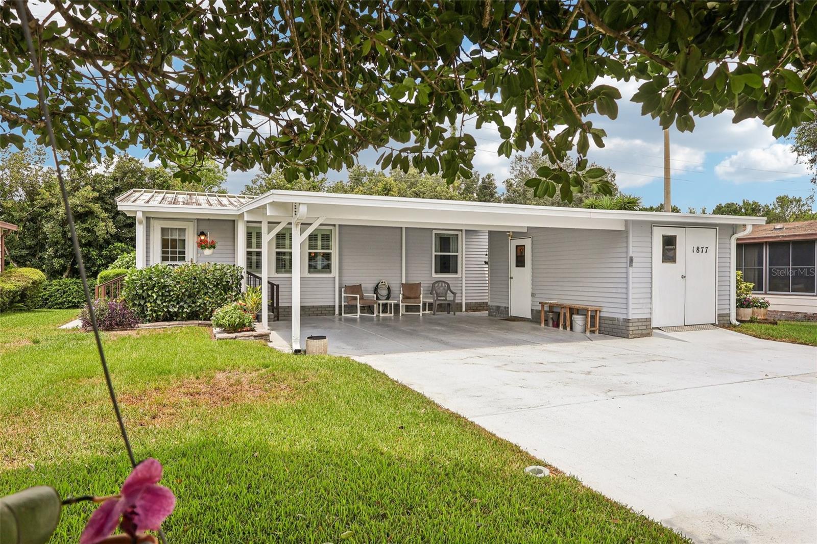 NO BOND and Golf Cart INCLUDED! Imagine pulling into your own slice of Florida living, where everything is ready for you to move right in and start enjoying. This beautifully maintained 2BR/2BA home greets you with a bright, open layout, vaulted ceilings, updated windows, and tasteful upgrades at every turn. Tile and laminate flooring flow throughout, complemented by plantation shutters and an updated kitchen with stylish cabinetry, a real Tiffany light fixture, newer stainless appliances, and a welcoming breakfast bar.
Inside laundry adds everyday convenience, while the Florida Room—fully under heat and air—boasts glass windows that open to a peaceful deck, perfect for morning coffee, evening chats, or entertaining friends. No rear neighbors mean added privacy, and you might even spot a friendly horse wandering by. The primary suite offers dual closets and a large tiled step-in shower.
Additional perks? Double carport, golf cart garage with workshop, and your very own 2014 Gas Yamaha golf cart ready for adventures around the community.