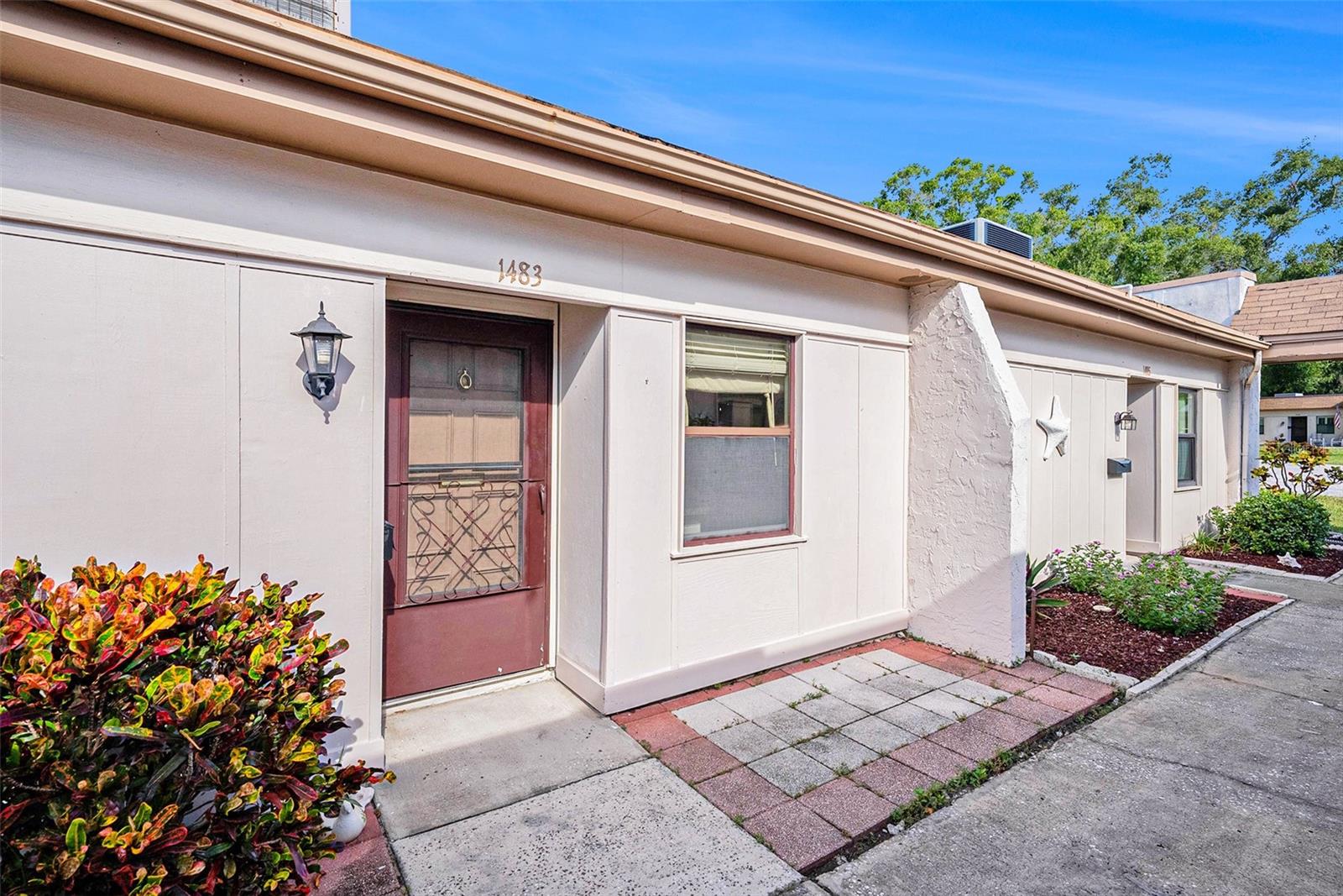 Welcome to Mission Hills, a charming 55+ community in the heart of Clearwater! This one-bedroom, one-bathroom villa offers a great opportunity to make it your own with some TLC. The kitchen opens up to a spacious living and dining room combo, perfect for everyday living and entertaining. Enjoy the added bonus of a bright back sunroom, ideal for a reading nook, office, or relaxing retreat. The nicely sized bedroom features a walk-in closet, and ceiling fans are found throughout the unit for added comfort. You’ll appreciate the convenience of having an in-unit washer and dryer, assigned covered parking, and an additional outside storage unit. Enjoy all the amenities Mission Hills has to offer, including a sparkling community pool, shuffleboard courts, and a welcoming clubhouse. Monthly HOA fees include cable, internet, water, and more. Located near Publix, shopping, dining, and just minutes from Ruth Eckerd Hall. With quick access to McMullen Booth Road, getting around town is a breeze. Schedule your showing today!