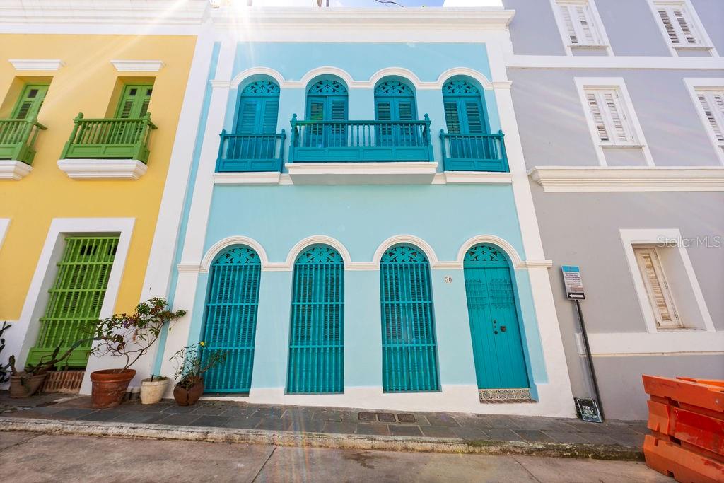 Step into a piece of history with this exquisitely renovated 2,716 SF Spanish Colonial masterpiece, nestled next to the Governor’s Mansion and steps to La Princesa Boardwalk in Old San Juan. Thoughtfully restored to preserve its timeless elegance, this two-story residence seamlessly blends historic charm with modern comforts.
From the moment you enter, you are welcomed by an air-conditioned grand room with soaring 20-foot ceilings, where a full-wall library invites both quiet reflection and sophisticated entertaining. Every step through this home tells a story, with intricate tilework sourced from the historic San José Church (circa 1810), adding an unparalleled touch of authenticity and character.
Original "soles truncos" archways stand as a testament to the home’s Spanish heritage, casting beautiful patterns of light throughout the space. Designed for both elegance and ease, the living room, dining area, and kitchen flow seamlessly through graceful arched openings to an indoor covered terrance and interior patio where natural light and fresh air create an inviting atmosphere for relaxation or entertaining. A conveniently located half bath is available for guests.
The newly crafted wooden kitchen, equipped with brand-new appliances and a washer/dryer, is enhanced by traditional arches and stained-glass “vitrales,” adding both beauty and functionality to the space.
Upstairs, you’ll find three spacious air conditioned bedrooms, three full bathrooms, and a laundry room. The two primary bedrooms feature custom closets, restored original wood floors, and double doors that open onto Old San Juan’s iconic balconies, offering picturesque views of the historic streetscape. An additional open balcony overlooks the indoor garden, providing the perfect spot to unwind. The property includes a full-power generator and a water cistern for added convenience and reliability.
Ideally located on San Francisco Street, this exceptional home offers both security, with a police station directly across the street, and convenience, just a short walk from the San Juan Cathedral, Plaza de Armas, and an array of fine dining restaurants. A rare opportunity to own a true Old San Juan treasure, this residence is a perfect blend of history, charm, and refined living.