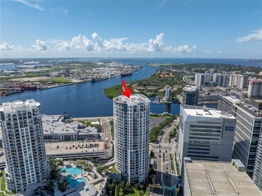 Welcome to 449 S 12th St, Unit 2702, Tampa—your penthouse in the sky. Nestled on the 27th floor of the prestigious Towers of Channelside, this exquisite residence offers a luxurious blend of comfort and style. Spanning 2,995 sqft, this expansive 3-bedroom, 3-bathroom, with two private balconies with nearly 500 sqft of private outdoor space. This home invites you to experience unparalleled living with breathtaking views, high-end finishes, and an ambiance of sophistication. Whether entertaining guests or seeking a private retreat, this penthouse delivers an elevated lifestyle in one of Tampa's most exclusive addresses. Upon entering, you’re greeted by an immersive whole-home audio system, seamlessly integrated into every room for an unparalleled auditory experience. The ceilings have been raised to their maximum height, creating a spacious and airy atmosphere that feels both expansive and intimate. In the versatile, large, bedrooms, Missoni wool carpeting provides comfort and understated luxury with each having en-suite bathrooms. The primary bedroom has more than enough room for a sitting area while also encompassing close to floor to ceiling windows to allow yourself to take in the water views. The primary bathroom is a true masterpiece. It features custom Ann Sacks tile on both the floors and walls, a unique Catchpool and Rye tub, and a stunning smoked mirror feature wall, all contributing to an open, airy, and undeniably sophisticated vibe. The secondary bathrooms have been reimagined with custom Walker Zanger tile, bringing a refined aesthetic to these spaces. Custom millwork in a sophisticated smoke color with bronze inlay adds depth and character throughout the home. The kitchen and entertaining areas are equipped with top-of-the-line Dacor appliances and rare Blanco Carrera countertops, with a full splash on the feature wall, exuding elegance and functionality. The living room is a work of art, featuring a stunning wall clad in hand-carved Nero Marquina marble with inlaid bronze details. The dining room offers a luxurious experience with its custom Phillip Jeffries horsehair feature wall, accented by a gold leaf abstract ombre detail. The column in the main living area adds warmth and texture with vintage, custom-colored terracotta bricks, a nod to timeless craftsmanship. The entire home is unified by custom French oak DuChateau wood flooring, with dynamic light coves that accentuate the sleek architectural lines, creating a play of light and shadow that enhances the home’s modern aesthetic. This penthouse is not just a living space, but an experience—luxurious, intimate, and truly unique. Every detail has been thoughtfully designed to showcase the true value and artistry of this exceptional home. This home allows for an exclusive lifestyle, complemented by top-tier amenities. Enjoy the resort-style pool with a spa and waterfall, perfect for relaxing or entertaining. This incredible property also includes 2 designated parking spaces as well as a separate storage room. Benefit from 24-hour concierge service and on-site property management, ensuring that your every need is met with the highest level of care. A designated parking garage provides convenience and security for residents. Situated in the heart of Tampa, this residence is just moments away from premier attractions like Amalie Arena, the Tampa Bay Riverwalk, and Sparkman Wharf, placing the best of the city at your doorstep.