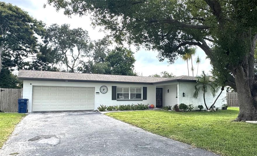 Filled with charm and character, this well-maintained home is ideally located in a quiet and very walkable Seminole neighborhood, close to the Pinellas Trail, less than 10 minutes from the sands of Madeira Beach, and less than 5 minutes from shopping, dining and the VA hospital. Warm Saltillo tile flows throughout the main living areas, complemented by new, trendy luxury vinyl flooring in the primary suite and one secondary bedroom. 

The living room features a large wood-burning fireplace as a striking focal point, while oversized windows welcome the Florida sunshine and offer a beautiful view of the shaded pergola and oversized fenced backyard—perfect for entertaining or relaxing (plus dog friendly!). The home also offers a spacious bonus room suitable for a home office, gym, guest suite, or additional living space.

The updated kitchen includes stainless steel appliances, quartz countertops, 42" white shaker cabinets, and bar seating. The primary bedroom suite features a king bed, oversized walk-in closet, dual-sink vanity, and modern walk-in shower. Two additional bedrooms are located on the opposite side of the home with a second full bath conveniently in between.

Though the home comes furnished, furnishings may be optional for leases over 10 months. Zoned for highly rated Seminole schools.