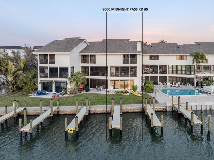This is one of the most unique condominiums for sale on Siesta Key with:
 • Full Views of the Gulf, Blind Pass Lagoon (connects to the Intracoastal Waterway, the ICW)- and Turtle Beach
 • 5-minute walk through a park to the beach
 • A heated waterfront pool steps from the back door
 • Use of a boat slip and kayak launch directly behind the unit – direct access to the ICW
 • 10 minutes by boat from the slip to the Gulf via Midnight Pass
 • A private patio and lawn between the unit and the boat slip
 • Fishing from the seawall or new piers directly behind the unit
 • A wood-burning fireplace
 • An oversized 2-car garage with inside access to the unit
 • Like a soundproof townhouse with no neighbors above or below
You will be mesmerized by water views and sunsets from every level of the home and from almost every room in the home. Enjoy spotting pelicans, herons, ibis, other waterfowl, jumping fish, and an occasional dolphin or manatee. Mature foliage blocks the eastward views of neighboring buildings. There are expansive impact resistant windows and sliding throughout. There is a large, screened, covered porch on the main floor with wall-to-wall windows and sliding doors. The eat-in kitchen is large, bright, and equipped with stainless steel appliances. There is a convenient pass-through from the kitchen to the dining room. The bedrooms are graced with cork flooring, which is beautiful, quiet, and comfortable to walk on.  The primary suite faces west with a private, screened porch where you will enjoy the sunset over the Gulf and beautiful reflections on the lagoon. The primary en suite bathroom features twin sinks, a walk-in shower, and a garden tub. All 3 bathrooms have granite countertops. The primary bedroom and second bedroom have walk-in closets. All bedroom closets are fitted with Closet-Tec fixtures.  The third bedroom features 2 single Murphy beds, each complete when opened with dimmable overhead lighting and a power outlet perfect for charging devices while you sleep. The laundry closet is conveniently located near the 3 bedrooms. The 2-car garage is larger than most at 22’ x 24’. The downstairs area is stunning, with bright light and wall-to-wall impact glass windows and sliding doors to your private patio. The location is ideal: just 10 minutes from the Stickney Point bridge to the mainland, within walking distance of restaurants, and adjacent to the final, southbound stop of the Siesta Key trolley, a free ride from your home to Siesta Key Village and its shopping, dining, and entertainment venues.