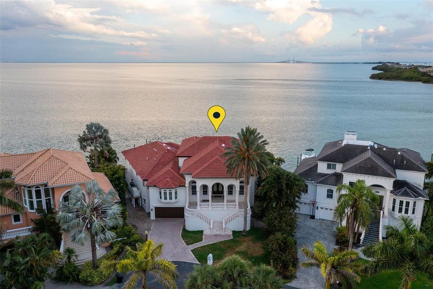 A Rare opportunity to own a luxury estate with unobstructed waterfront views. This three-story Mediterranean masterpiece features five bedrooms, an office/library, 5 full baths, and 2 half baths. One of only seven homes situated at the exclusive gated community of Paradise Pointe. Enjoy breathtaking water views from every room while watching dolphins frolic along the sea wall. The ground level is nearly 4400sf and features a 2000+ bottle wine cellar, theater with game room, and garage parking for 10 vehicles. The main level is 4300sf and has soaring 25ft ceilings with direct views of the Sunshine Skyway, nightly light shows, and the Tampa Bay skyline. The top floor is nearly 1000sf and features a wet bar, exercise room, and additional guest quarters. This waterfront estate offers a fusion of French décor and Italian-inspired design, with amenities such as an amazing veranda, elevator, negative edge pool, recently completed roof, grand dining room, breakfast area, oversized master bedroom, and much more. Centrally located to the beaches, Tampa, and Sarasota. A boater's paradise with deep water access for yachts and sailboats. Only a 10-minute boat ride to the St. Petersburg downtown restaurants and shops. Florida living at its finest. video tour* https://youtu.be/ps-W5w6bHtc