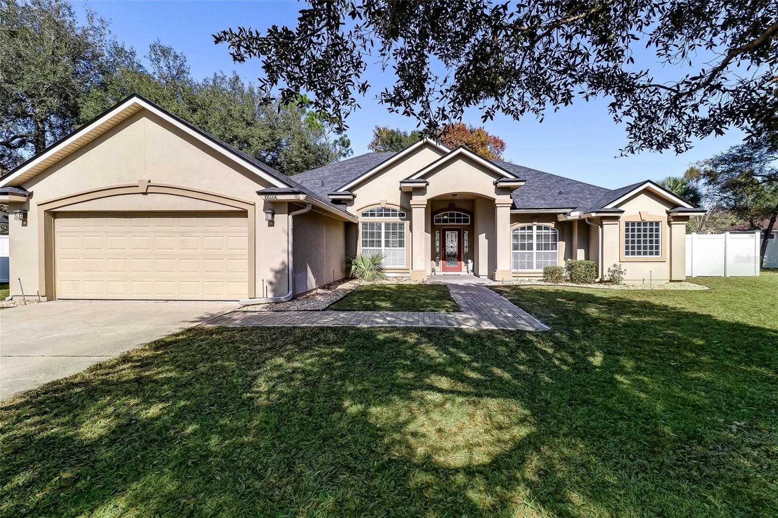 This beautiful 1 story home is your perfect oasis! Delight in 4-bedrooms, 3 full bathrooms, a cozy foyer, a spacious living room, separate formal dining area, a family room with a fireplace, and a kitchen with 42-inch cabinets, island, breakfast bar and breakfast area. The perfectly manicured fenced backyard and screened-in lanai provides tranquility and fun in equal doses. Enjoy 4-6 driveway parking spaces and a two car garage, a separate laundry room, and a brand new roof installed in April 2022. After a long day, come home to the owner's bedroom on the east end of the home with its two spacious walk-in closets, tray ceiling, upgraded ceiling fan, crown molding, ensuite bath, separate vanities, private water closet, separate shower, and jacuzzi tub. The fourth bedroom can be used as an office with its full bath adjacent, as well as direct access to the lanai and backyard. For your convenience, 3 out of the 4 bedrooms offer ample walk-in closets. This extraordinary home has impeccable interior painting and boasts top notch features including a sprinkler system, whole house sound system, high ceilings, and more. Conveniently located minutes away from shopping, dining, and the beach. Come visit this outstanding property for yourself and experience the ultimate in charm, luxury, and comfort!