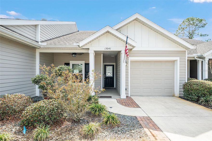 Located within the Villages of West End, this thoughtfully designed residence balances comfort, efficiency, and a refined sense of ease. A well considered layout unfolds, offering two bedrooms and two baths designed for both daily living and quiet retreat. Plantation shutters throughout introduce a timeless architectural detail, lending cohesion and softness to each space. The kitchen anchors the home with elegant white cabinetry, beautifully toned quartz countertops, and a glass tile backsplash that adds subtle texture and depth. Stainless appliances, an undermount sink, and generous bar seating beneath pendant lighting create a setting that feels both polished and functional. Just beyond, the dining area flows naturally into a bright and inviting living room, where French doors open to the outdoors and a coffered tray ceiling adds dimension overhead. The primary suite is expansive and calming, finished with warm toned carpeting and an ensuite bath. A spacious walk in closet connects directly to the indoor laundry room, an intuitive design choice that enhances everyday practicality. The secondary bedroom offers a charming and light filled space suitable for guests, work, or quiet downtime. A screened back porch extends the living experience outdoors, providing shade and comfort while overlooking a peaceful greenbelt and retention area. With no rear neighbors, the setting offers a sense of privacy rarely found in low maintenance communities. Community amenities, a one car garage, and a convenient location near I 75, shopping, dining, and local activities complete the picture. This is a home designed to support an easy rhythm of life while remaining connected to everything that matters.