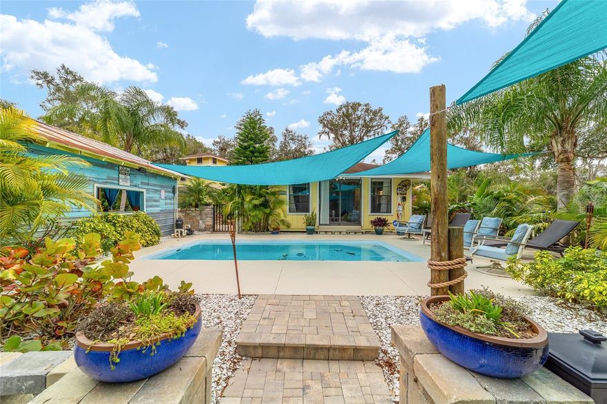 THIS PLACE WOULD MAKE A GREAT Air B&B!!!! Nestled on a sprawling 5.29 acres, this extraordinary property presents a unique opportunity for a discerning buyer. The centerpiece is a charming three story home, boasting three bedrooms and two bathrooms, complete with a two-car garage. What makes this offering truly exceptional is its dual address- 19785 SE 156th Street and 19855 SE Highway 42- encompassing six distinct parcels and three wells. This allows for incredible flexibility whether you envision building a private compound or exploring the potential of selling off individual parcels. The backyard is an entertainer's paradise, a meticulously landscaped oasis featuring a pool house, an inviting inground pool, a fun tiki bar perfect for grilling, and a relaxing outdoor cabana. Adding to the versatility is a large workshop, situated within the A1 zoning, while the home and surrounding parcels enjoy R4 zoning. Privacy is paramount with a gated driveway securing this haven, located a mere quarter mile from Ocklawaha River, providing access to the chain of lakes, and only 12 miles from The Villages. Furthermore, the property includes two camper hookups, a 50 amp and a 30-amp, each with a dedicated water supply. This one of-a-kind property offers endless possibilities, and a showing requires a one hour notice due to the presence of a guard dog that must be secured.