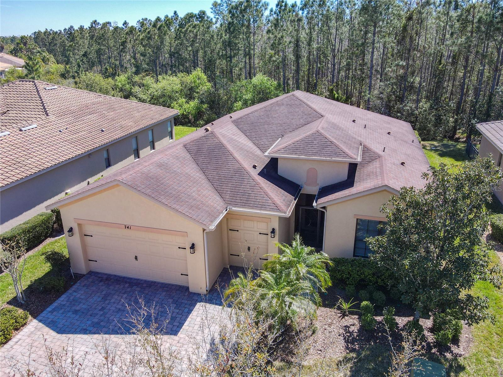 Fantastic Cannes Model on a conservation lot. Starting at the upgraded stunning lead crystal entry door, you walk into the kitchen that includes 42" pecan cabinets, granite countertops, backsplash, undercounter and over cabinet lighting and a wine glass rack with a separate breakfast nook. Off the kitchen is the laundry area with newer Maytag Washer and Dryer and matching cabinets. This home includes diagonal ceramic tile flooring throughout. All window treatments including the Hunter Douglas blinds in the kitchen and the dining room, upgraded fans throughout, 2 master suites. Master suite 1 has custom cabinets installed in the walk-in closet. Master suite 2 has a walk-in closet, a 3rd bedroom with an adjacent full bath, and a large floor mounted Liberty safe in the 2nd master bedroom. The bathrooms include upgraded tile with lístelos and designer sinks. Custom Crown Molding in all public areas of the home. Double pane low E insulated glass in all windows. All toilets are senior height, elongated high efficiency. The large 32 x 14 screened lanai includes 2 concrete slabs outside of screened area for your grill or a seating area, a 3" insulated roof, 3 outdoor fans and Podocarpus hedges on both the East and West sides for privacy. Air Conditioner was replaced in 2019 with a 15V seer dehumidification system series 3-ton heat pump and a new compressor was installed in 2024.
