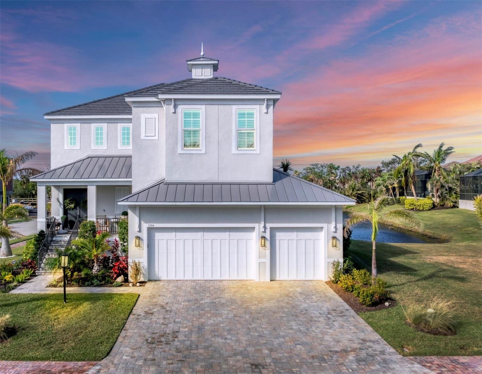 This stunning two-story waterfront residence perfectly blends modern luxury with coastal tranquility. Built in 2022 and located in the coveted, maintenance-free gated community of Legends Bay, it boasts five bedrooms, four bathrooms, and an expansive 3,848 square feet of living space. What sets this home apart from others is - a GENERAC WHOLE HOUSE GENERATOR, POOL BATHROOM, VACANT LOT NEXT DOOR THAT CANT BE BUILT ON (YOU BENEFIT FROM THE PRIVACY AND SPACE), A DOG RUN JUST OFF THE POOL AREA (EASY FOR PET AND YOU!), CUSTOM PLANTATION BLINDS, TOP-OF-THE-LINE LIGHTING, $10,000 of UPPER/LOWER STORAGE SYSTEMS IN GARAGE, NEW LAUNDRY SINK, FPL LEVEL 2 EV CAR CHARGER, $30,000 in ENHANCED LANDSCAPING, CUSTOM LIGHTS AROUND POOL AND NEW FANS ON BALONY & PATIO. Designed with both style and functionality in mind, it features all-impact glass for peace of mind and efficiency. At the heart of this home lies the spacious great room with high ceilings and an abundance of natural light, creating a bright and inviting ambiance. Sliding doors open to the screened patio, enhancing the flow between indoor and outdoor living. Outdoors is a true retreat complete with a sparkling pool, generous covered seating area, and peaceful lake views, offering the perfect space for relaxation and entertainment. The kitchen is a chef’s dream featuring a large island with seating for four, sleek tile backsplash, stainless steel appliances, and a statement range hood. Upstairs, a versatile loft area can be a great bonus/game room leads to a screened balcony offering captivating views of the lake and Sarasota Bay. Two en-suite bedrooms provide privacy and comfort, while the generous primary suite is a true sanctuary, featuring a spa-like bath with dual vanities and a glass-framed walk-in shower. , custom lights around the pool, and new fans on both the balcony and patio. SOME FURNITURE IS AVAILABLE. Located less than three miles from IMG Academy and just a golf cart ride from IMG Golf Club, this exceptional home is perfectly positioned to enjoy the best of Sarasota’s lifestyle, with its blend of luxury, comfort, and proximity to world-class beaches, dining, and cultural attractions.