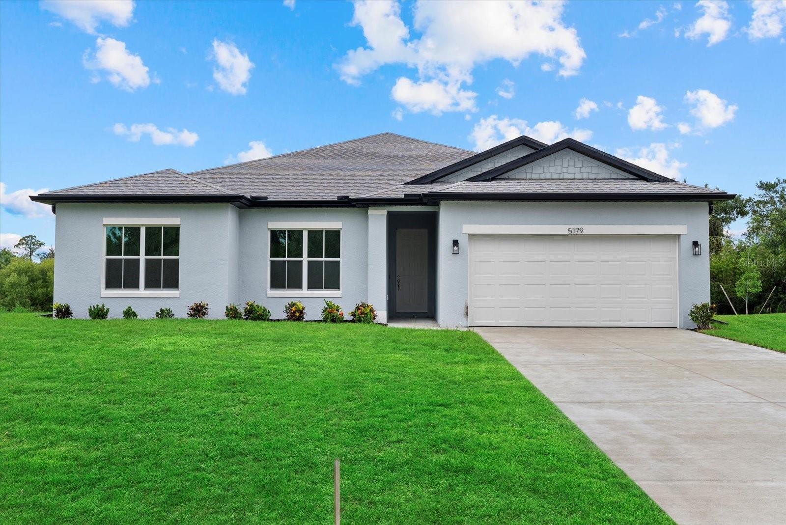 New Construction! Move-in Ready! Seller Concessions avaliable for closing costs or Interest Rate Buy-Down. This beautiful 4-bedroom, 3-bathroom home is ready for you to call home. Step inside and be greeted by the spacious great room with soaring 9'4'' ceilings and elegant 8' doors throughout. The modern kitchen INCLUDES a stainless-steel Samsung appliance package, beautiful quartz countertops, and an open layout perfect for entertaining. The Primary bedroom comes complete with a tray ceiling, walk-in closet, and a spa-like ensuite with double vanities. The fourth bedroom, located at the front of the house, offers privacy with its own ensuite bathroom, perfect for guests or extended family. This home is packed with high-end finishes, including hurricane-impact windows, tiled showers, stylish and durable flooring, irrigtion system, and a Ring doorbell. Enjoy Florida living year-round on the covered lanai, ideal for outdoor relaxation. Selling concessions are available to make your move even easier! No HOA fees, no CDD. Schedule your showing today!