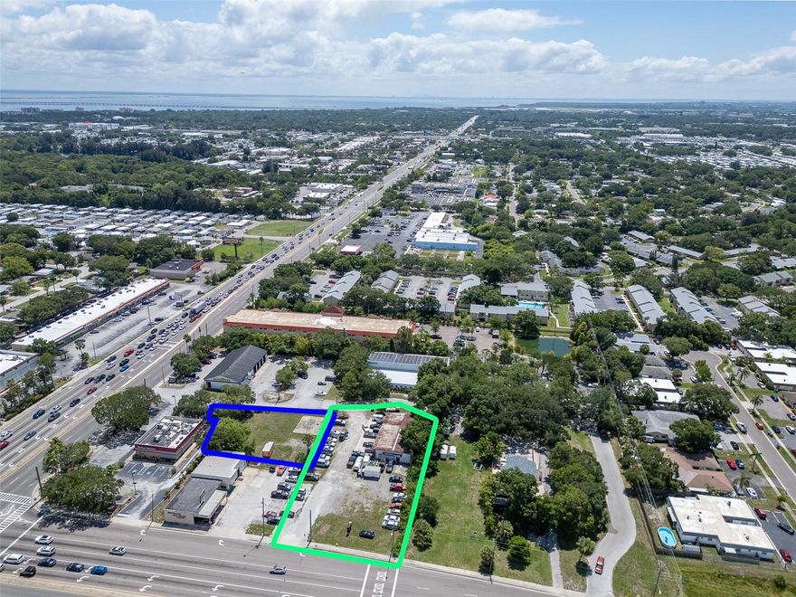DISCOVER YOUR DREAM DEVELOPMENT OPPORTUNITY!!! This listing screams LOCATION, LOCATION, LOCATION!!! This two-parcel totaled (.98) acre sale is located on the corner of East Bay and Belcher Roads and offers HIGH TRAFFIC and MAXIMUM VISIBILITY reaching over 63,500 daily. This rare opportunity offers a multitude of potential and return on investment. Located along the heavily travelled Belcher Rd, this nearly one-(.98) acre property offers flexibility to bring your dream project to life whether retail, medical, or flex. This listing also features a 3520SF industrial building currently serving as a successful auto repair shop (4 Bays with Rolling Doors) with its own lobby, two separate self-contained offices with 2 bathroom, and plenty of parking and room to expand. Less than a mile away from US 19, it is surrounded by multiple, high retail and commercial businesses such as Publix, Chase Bank, Tijuana Flats, CVS, Goodyear Tires, Verizon store, and more, and is central to Saint Petersburg, Clearwater and Tampa.