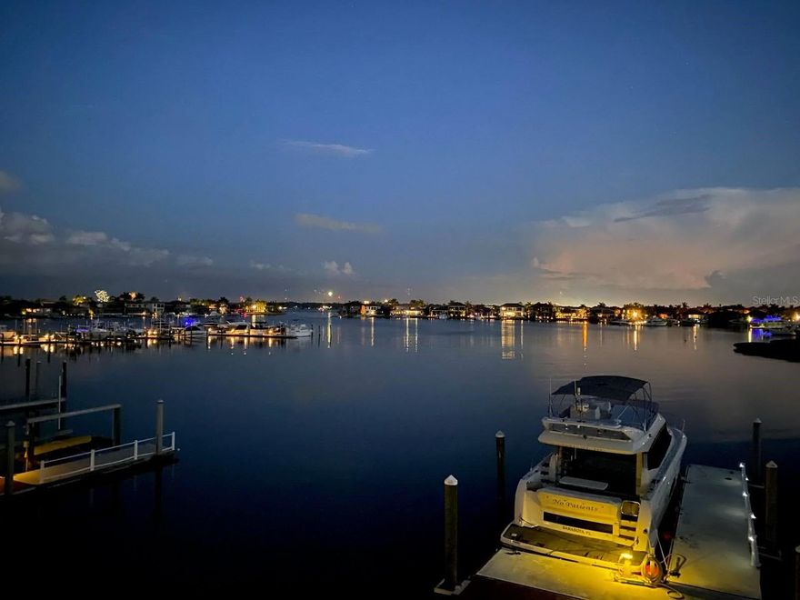 With unparalleled views of the marina and harbor at Riviera Dunes, this custom-built boater's paradise is filled with bright, open living spaces and a flowing design. Featuring 112' of waterfront, the estate provides for a wide, 180 degree expansive view of the 90 acre harbor. Built in 2007, the 4 bedroom/4.5 bath estate features a family room, breakfast room, home theater, billiard room and  gymnasium (4th bedroom) - a 2,000 bottle wine cellar, gourmet kitchen, outdoor living spaces with covered dining area, fireplace, grille/wet bar/outdoor kitchen, heated pool with spill-over spa and waterfall, 2 attached garages with 2 spaces each and a paved circular driveway.

The facade is adorned with stone columns, arches and recessed art niche with Italian ceramic. Guests enter through the custom glass double entry doors with elegant palladium windows and into the Grand Room, with a large aquarium window and a panoramic view of the lanai and harbor. Fabulous for entertaining, the Grand Room is embellished with recessed wall niches, custom tile and a double step ceiling.

The dining room is garnished with a full wall arch, stone columns and an octagonal step ceiling. The gourmet kitchen is accessorized with a professional gas cooktop housing 6 burners, a grille and pot filler, convection oven, side by side refrigerator, wine refrigerator and stainless steel appliances. 

The primary suite offers a double step ceiling with recessed lighting, vestibule with art niche and custom tile, oversize walk-in closets and disappearing sliders with full lanai/harbor view. The primary bath features custom cabinetry and shelving,  jacuzzi style tub with stone columns and walk-in shower with wall & oversized rainfall shower. With its double entry doors and built-in window seat, the french salon spills out to the veranda. 

The protected harbor at Riviera Dunes is a hurricane hole six miles inland and just off the Manatee River and is thought by many to be the safest waterfront community on the west coast of Florida. The private 50' floating boat dock is equipped with shore power and city water and can accommodate vessels with a draft of up to 18', 60' of waterline and a practically unlimited beam. The 2' wide seacap is protected by an enduring riprap barrier that is 20' wide. Easy access to Intracoastal Waterway and the Gulf. While no home is hurricane proof, this one has a proven track record. In 2024, three storms affected the west coast of Florida and it remained unscathed, high and dry.

Riviera Dunes is a gated marine community within the city limits offering a plethora of amenities. Two properties in Riviera Dunes have lot sizes much larger than all the others and this is one of them. It sits on 1.5 lots or about a third of an acre. The property has a tropical feel with lush, mature landscaping and fauna making it the pinnacle of home lots in all of Northshore at Riviera Dunes.

When it comes to keeping your 60' yacht in the backyard, this home is your best value anywhere in the State of Florida.