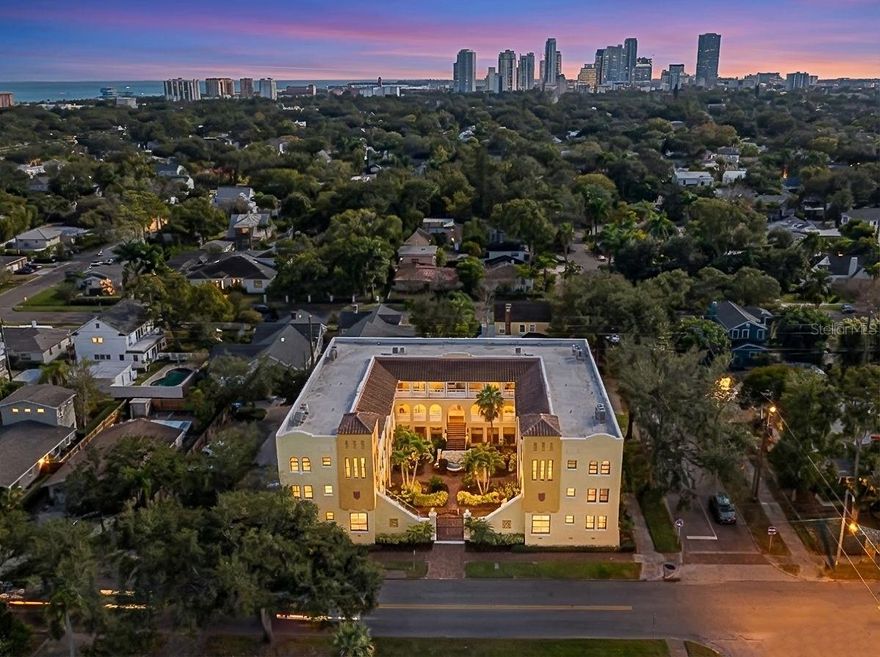 This rare and coveted top-floor corner unit at The Hegrado, locally known as the historic Magdalena building, offers over 1,200 square feet of living space within an intimate, gated community of just 15 residences. Featuring Mediterranean-style architecture and charm, the property offers courtyard views overlooking Granada Terrace, abundant natural light, and preserves some of the historic stained glass windows. Ideally located just blocks from Coffee Pot Bayou, Bayfront walking, nearby parks, and all the convenience of Old Northeast and St. Petersburg living! The thoughtfully designed layout lives larger than expected, with a spacious living area, separate office nook, two bedrooms, two remodeled bathrooms, a laundry area, and a bonus finished attic space offering flexible use. The open and bright kitchen features solid wood cabinetry, ample granite countertop space, and upgraded stainless steel appliances, including a new induction range, oven, and dishwasher. Additional interior enhancements include refinished hardwood floors throughout the second floor and stairwell, new impact-rated windows, shades, and interior painting completed throughout. Second-floor French doors open to a private patio overlooking the courtyard, enhancing the home’s indoor-outdoor appeal. Storage is exceptional for a condo, with finished attic storage within the unit, a private exterior storage closet, and additional basement storage. The gated building is surrounded by lush landscaping and features a beautifully maintained courtyard. The unit includes one assigned, deeded parking space, along with available guest parking. Don’t miss the opportunity to experience a rare combination of location, character, meaningful upgrades, and livability—schedule your private showing today!