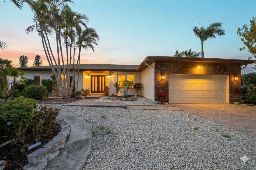 Enjoy your very own mature avocado tree right in the front yard of this waterfront gem!  Nestled in the highly sought-after Coral Shores community—a true Boater’s Paradise where timeless elegance meets the ultimate Florida lifestyle. This beautifully maintained 3-bedroom, 2-bath single-family home features a spacious 2-car garage and sits high on a rare 10+ elevation, offering peace of mind with no history of flooding. Positioned on the widest canal in Coral Shores, this home offers serene water views overlooking the quiet, beautifully manicured Mount Vernon community—a rare and peaceful backdrop. Designed for effortless indoor-outdoor living, nearly every room opens through sliding glass doors to either a screened-in pool area or an open deck, ideal for entertaining or relaxing in a hot tub-ready space. Boating enthusiasts, take note: Private dock with two boat lifts (one up to 12,500 lbs), direct canal access to the Bay. No fixed bridges to the Gulf! Inside, enjoy the charm of authentic imported Italian tile flooring, a wood-burning fireplace, and a remodeled kitchen/great room with granite countertops and unobstructed canal views. The Thermador cooking appliances, including two full ovens, make this kitchen a chef’s dream. Premium Features Include: Hurricane-proof windows and doors, New pool heater/cooler (2021), and New roof (2022) with transferable warranty.  Nearby, you’ll find quartz-white sand beaches, just minutes away—perfect for sunset strolls and weekend getaways. With no mandatory HOA and no lease restrictions, this home is not only a tranquil retreat but also a savvy investment opportunity. Located close to Bradenton’s top dining, shopping, entertainment, and coastal parks, this home is the perfect blend of comfort, convenience, and coastal elegance. Don’t miss your chance to own this one-of-a-kind waterfront sanctuary!