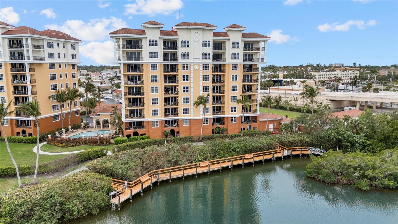PRICED TO SELL - This is your chance to grab a waterfront gem in sunny Venice, Florida—well below market value and with serious buyer perks. Located on the 7th floor of a gated community, this condo offers unobstructed Intracoastal Waterway views where dolphins and manatees pass by daily. From sunrise to sunset, absorb the coastal life from your private front patio and lanai—perfect for sipping your morning coffee. Inside, the open-concept layout is perfect for entertaining, while a private office easily converts to a guest bedroom. Step right outside to the Venetian Waterway Trail, offering scenic biking and walking paths along the shoreline. Just 1.1 miles to Venice Beach and 16 miles to world-renowned Siesta Key, this condo delivers coastal convenience and comfort. Impact-rated windows and a clean hurricane history give you peace of mind, while a rare covered parking space protects your car year-round. The primary suite is a relaxing retreat featuring coffered ceilings, crown molding, and calming water views. Whether you're looking for a seasonal getaway or a full-time Florida lifestyle, this move-in-ready condo is the total package—and the seller just sweetened the deal with an entire year of HOA dues paid upfront.