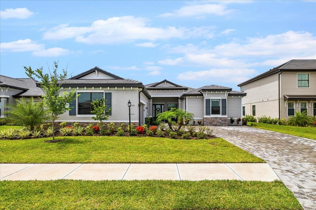 Experience luxury and peacefulness in this stunning remodeled 3-Bedrooms, 3-Full Bathrooms, 2-Half Bathrooms and a Den home! This Agostino model is an Estate Home Collection with only 8 homes built throughout the community. Enter the home through a big porch into a grandiose 13’ tall foyer with a beautiful chandelier, tile throughout the house, 10’ tall walls, Hunter Douglas powered blinds and fans. The heart of the home features an open-space concept with spacious gourmet kitchen with large island and Reverse Osmosis system. The Great Room features tray ceilings and grand sliding glass doors that sweep across the wall and flows to a spacious lanai. This model is the only one in the community that offers an independent patio bathroom with storage. Nestled at the back of the home for increased privacy is the Master Bedroom with two spacious walk-in closets and remodeled bathroom that includes, double shower, split vanities and wall-width mirrors. The other 2 Bedrooms are in each corner of the house for privacy, with their independent remodeled bathrooms. The Den is located to the side of the foyer with a remodeled half-Bathroom in between. The renovated Laundry room is fully equipped with a convenient sink, cabinets and spacious storage closet. This exceptional home built in a 60’ lot in a cul-de-sac, offers a Preserve view with backyard Water view, offering the perfect backdrop for relaxation. The community of Lorraine Lakes has resort-style amenities with restaurant, pickle ball court, tennis court, basketball indoor and outdoor courts, gym, sauna, 2 pools, splash pad for kids and a playground. An activity Director regularly hosts themed events that engage the community for a family-oriented environment.