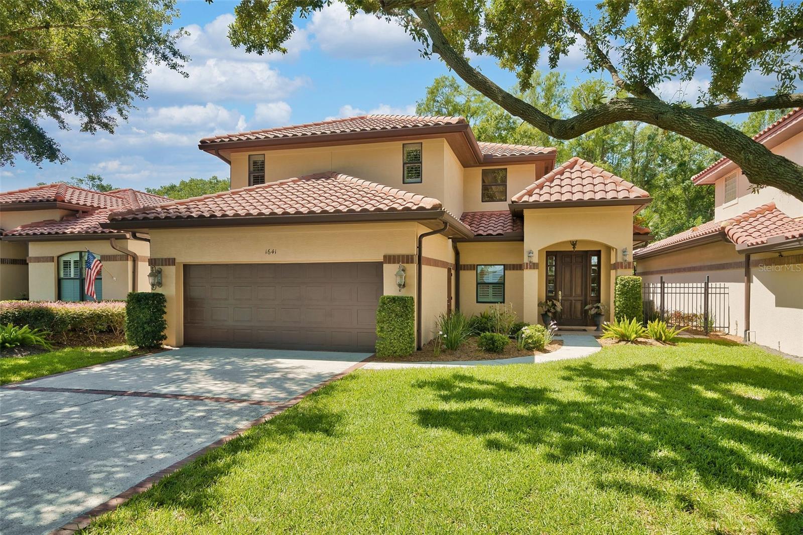 Welcome to a thoughtfully designed, first time on the market home in the sought after gated community of Country Club Villas. Just moments from the Country Club of Orlando, College Park’s charming main street, and the exciting new Packing District, this spacious residence offers flexibility, comfort, and timeless style. The open concept layout is enhanced by soaring coffered ceilings and flows seamlessly to a large covered patio with a summer kitchen, ideal for entertaining. The kitchen is beautifully appointed with stainless steel appliances, granite countertops, travertine floors, and a large pantry. Just off the kitchen, an oversized mudroom/laundry room connects to the two-car garage and contains a second refrigerator, a utility sink, and ample space for kitchen prep or additional appliances. The primary wing includes two bedrooms, offering options for separate sleeping quarters, a private study, or a home gym. All lower level doorways are handicap accessible, making this an excellent choice for those seeking to age in place. Upstairs, you'll find two additional bedrooms and a versatile loft space. Recent updates include brand new carpet throughout, a new refrigerator (2024), and two new AC units (2024). The home also features a gas fireplace, gas tankless water heater, generous storage, and a private, walled backyard. Filled with natural light and thoughtfully designed for long term comfort, this home offers an exceptional lifestyle in a prime location.