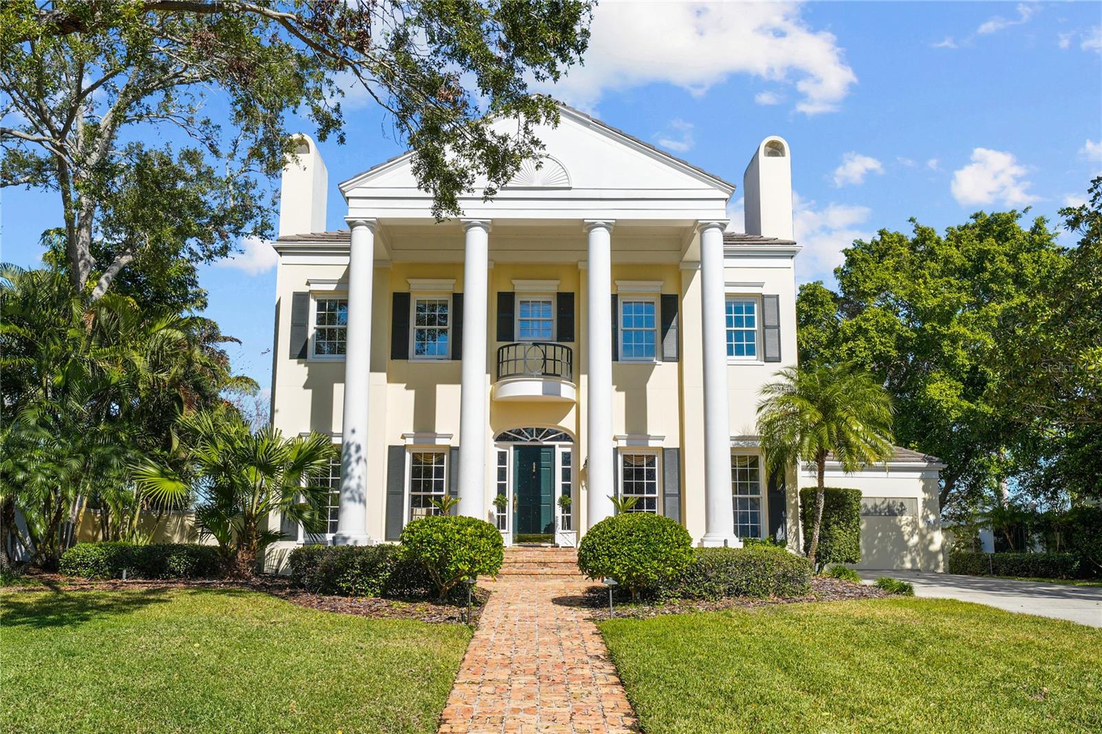 Elegant 5 Br Waterfront Greek Revival Sun filled beauty, 3 houses from the Open Bay in Tampa’s top guarded and gated community of sought after
Culbreath Isles. This 1989 custom built residence featured ten foot ceilings up and down, an open floor plan, 3 fireplaces, beautiful inlaid wood floors, French doors leading to old Chicago brick porches, exquisite moldings, and custom cabinetry throughout. The gourmet kitchen features a Viking gas stove and Carrera marble counters and Rohl plumbing. The primary bedroom suite features 3 large walk-in closets, an elegant marble bath, a private balcony to watch the glorious sunsets of Tampa Bay and a generous bonus room to serve as office or gym. A first floor bedroom /office has a full bath and large walk-in closet. The home was built for family living
as well as large scale entertaining and has been featured in Tampa Bay Magazine and Metro. Now it’s time for the next generation to build a new dream home to create new memories .