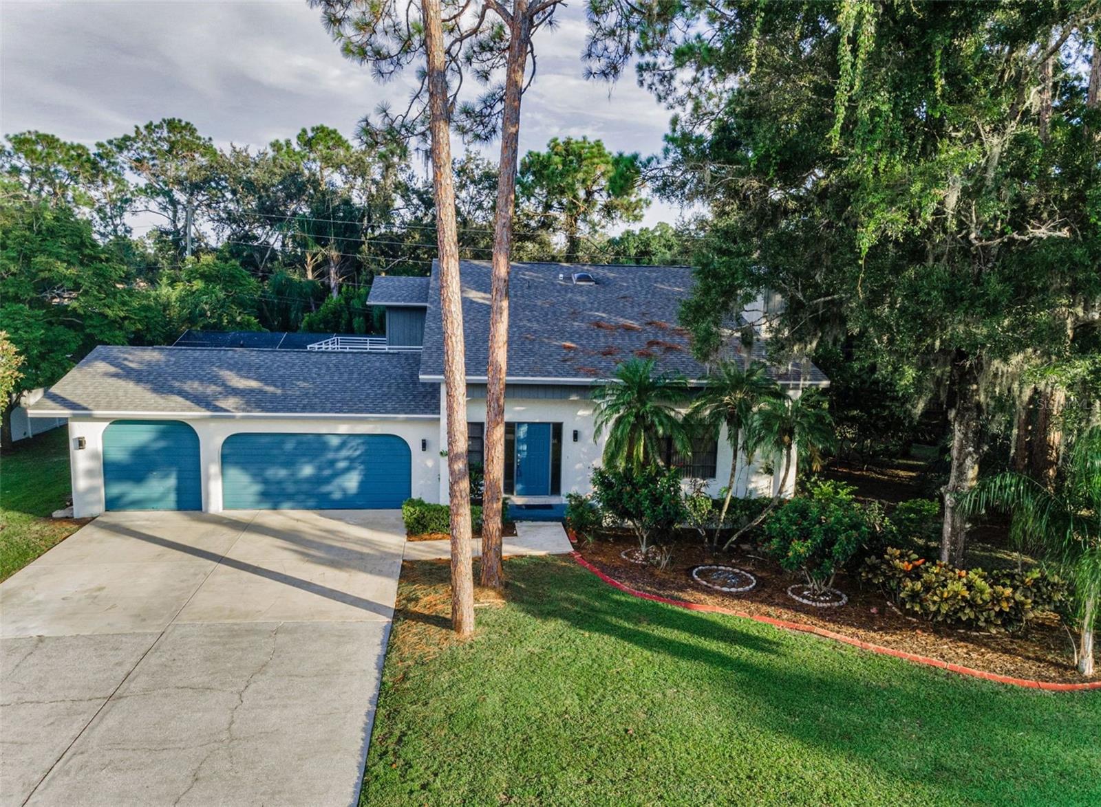 One or more photo(s) has been virtually staged. The perfect family home in the popular East Lake corridor of Palm Harbor, is located in the highly desirable Tarpon Woods subdivision. This exceptional two-story pool home has a flowing floor plan that is ideal for entertaining family and friends. The living room with fireplace and soaring vaulted ceiling is light and bright and adjoins the dining room. The kitchen has wood cabinets and granite countertops with a breakfast bar and recessed lighting and opens onto the family room. An important feature is the primary bedroom with en-suite bathroom located on the main floor. The additional bedrooms and bathroom are on the second level along with a spacious and airy loft that can be used as an office or reading area. In addition there is a outdoor deck that can be accessed through the hall or one of the bedrooms, a great place to watch the stars or enjoy a cool evening breeze. The guest bath has a tub/shower combo and a skylight directly overhead. The pool area is screened in and has pavers and looks out to a wooded area which provides a great amount of shade and privacy. The HVAC is newer and was installed in 2023.The oversized three car garage with has plenty of room for a golf cart to get to the nearby golf course. Don't miss out on this great opportunity and schedule your appointment today.