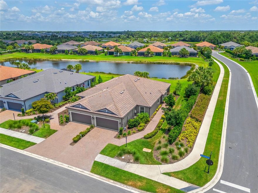 Move-In Ready Luxury Upgraded Premium Waterfront End Unit Villa in Skye Ranch. Experience luxury living without the wait of construction. Located in the highly desirable gated Esplanade at Skye Ranch, this impeccably upgraded Taylor Morrison "Ibis" model sits on a premium waterfront lot. The open-concept design features tons of upgrades: Plantation shutters, tray ceilings in primary suite, dining room & study, 5" crown molding in living, dining and kitchen, 8' interior doors, 8' Crystalline Front Door that floods the entryway with natural light, 5" base, luxury vinyl floors, tile floors, ceiling fans through out, and sophisticated quartz countertops. Two spacious ensuite bedrooms offer ultimate privacy, while a versatile flex room easily serves as a home office, den, or third bedroom. A chef’s kitchen boasts stainless steel appliances including French Door refrigerator, upgraded LED under counter lighting, stunning tiled backsplash, premium cabinetry, and an expansive quartz counter perfect for entertaining. The indoor laundry room features upgraded 42" upper cabinetry, lower cabinetry, laundry sink, and GE Washer and Dryer. The garage floor is even upgraded with acrylic stain and sealed floor plus there is a keyless pad for the garage door. Outside, enjoy serene water views on the extended paved screened patio with neighbors on one side, providing unparalleled comfort and privacy. Exclusive access to Esplanade’s resort-style amenities. "The Hub" offers state-of-the-art techno gym equipment, variety of classes including yoga flow, mat Pilates, and guided meditation. Grab a coffee at the on-site cafe', browse boutique style retail, or relax at the resort pool with cabanas. There is also pickleball, bocce and tennis courts, nature paths and trails, fireside seating, putting green, corn hole and a bark park. Situated just minutes from Sarasota’s world-class beaches, premier shopping, and dining, this home offers the ultimate Florida lifestyle. Schedule your private showing today and discover the epitome of Sarasota living.
