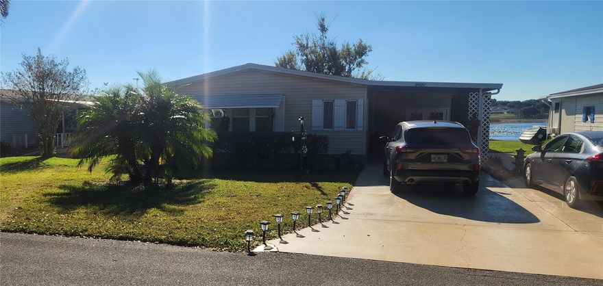 Beautiful waterfront home in the desirable gated golf community of The Plantation at Leesburg. Spacious 2-bedroom, 2-bathroom, open-concept, double-wide manufactured home with an enclosed lanai overlooking the Dilly Marsh conservation area. Quiet cul-de-sac street with minimal traffic. Carport and golf cart garage. Large indoor laundry room with washer, dryer, and ample storage space. Wet bar and custom entertainment center with space for a large-screen TV. Many upgrades and features: (including double-pane windows, 16 SEER air conditioning, granite countertops in the kitchen, side-by-side refrigerator with ice and water dispenser, quiet dishwasher, garbage disposal, smooth-top range with four burners plus an additional wall oven, impressive large kitchen pantry, Murphy bed in the second bedroom, walk-in closets, ceiling fans/lights, and hardwood and tile flooring). The Plantation at Leesburg is a lovely 55+ gated golf community with three community centers featuring swimming pools, hot tubs, exercise rooms, sauna, tennis, bocce ball, shuffleboard, horseshoes, archery, fishing, and many more activities, shows, dances, and clubs.