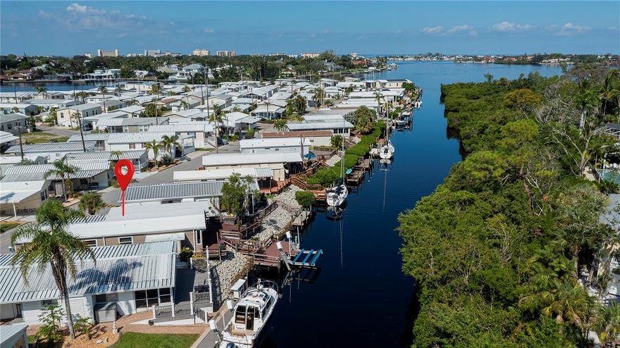 Rare opportunity to own an affordable waterfront home in Venice, Florida with direct boating access near Venice Island. Located in Harbor Lights, a desirable 55+ co-op community, this 3-bedroom, 2-bath mobile home sits on a deep-water canal with no fixed bridges and quick access to the Intracoastal Waterway and the Gulf in approximately 5 minutes. Inside, the bright and inviting floor plan features granite countertops, stainless steel appliances, vinyl flooring throughout, and a cozy dinette overlooking the canal. Wake up to peaceful water views and enjoy the relaxed Florida lifestyle every day. Step outside to the spacious waterfront deck, perfect for entertaining, dining outdoors, or enjoying your morning coffee by the water. Boaters will appreciate the private dock with electric and water, plus a 7,000 lb boat lift for easy access to your next day on the water. Harbor Lights is ideally located directly on the Intracoastal Waterway near Dockside Waterfront Grill and just minutes from the north bridge to Venice Island. Walk or bike to historic downtown Venice for shopping, dining, farmers markets, and year-round events. Venice Beach, golf, restaurants, and medical facilities are all nearby. Community amenities include a heated pool, tennis court, shuffleboard courts, and an active social atmosphere. Whether you're looking for a seasonal retreat, full-time residence, or boating lifestyle property, this home offers outstanding value in one of Venice’s hidden gems. Affordable canal-front homes with a dock and boat lift this close to Venice Island are hard to find. Schedule your private showing today.
