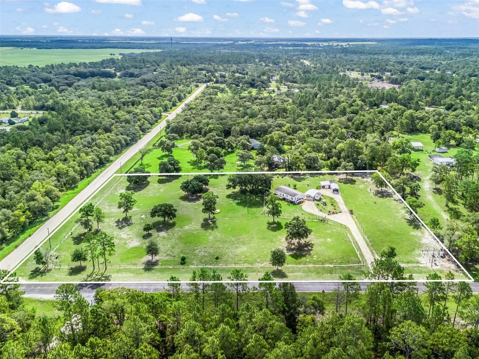 Peaceful Country Living on 5 Acres in Morgan Farms! Welcome to this beautifully maintained 3 bedroom, 2 bathroom 2012 manufactured home offering 1,400+ sq ft of comfortable living space. Nestled on 5 acres with a meticulously kept yard, this property offers both privacy and convenience. Enjoy the ease and convenience of paved access to the house and a dirt road on the side where you could add a second driveway! Outside, you’ll find two covered parking areas: a 12x25 carport (2024) and an 18x30 carport (2023), perfect for vehicles, boats, or equipment. A well-equipped shed includes a generator hookup to power the house and well, providing peace of mind during outages. The land is dotted with a variety of fruit and citrus trees, giving you your very own seasonal harvest. A gem in Morgan Farms—room to breathe, move-in ready, and full of natural beauty. Come experience all this charming property has to offer! Located 1 mile from the Black Prong Trail Head. 15 minutes from Williston and 25 minutes to Dunnellon.