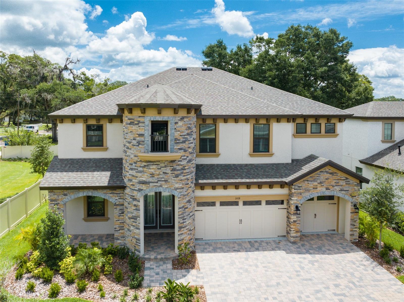 WELCOME HOME! This Verona floorplan by Homes by West Bay with its Mediterranean elevation is just what the doctor ordered! The 3-car wide paver driveway and front porch enhance this already Castle-esque curb appeal. When you enter the home your eyes will be drawn to the high ceilings and wood grain tile laid throughout the first floor, complementing the wide open living area. At the front of the home there is an enclosed study with beautiful French doors! The kitchen truly is the center of this home with absolutely stunning quartz counters, maple slate cabinets, gorgeous backsplash, HUGE island and gourmet kitchen design. The main island offers storage from both sides and an additional drop-down island perfect for informal dining. This space is made for large gatherings! The open, oversized kitchen overlooks the family room, which features huge sliders allowing you to gaze out into large lanai and private back yard. The yard has plenty of room for a pool! Off the family room you will find the 5th bedroom and one of the full bathrooms or pool bath. This area also could work as an in-law suite. Upstairs you will find your additional 4 bedrooms and ginormous bonus room. The master bedroom is not only spacious, it is split off from the others and offers great privacy. The master bath is breathtaking, with soaker tub and massive super shower with two shower heads and upgraded tile. Let's not forget about the oversized master closet! Two other bedrooms with walk-in closets share an upgraded Jack and Jill bathroom with a linen tower that splits the sinks and offers additional storage. The final bedroom is just as private as the rest and has another upgraded bathroom right outside its door. The laundry room is located upstairs for convenience and has a separate laundry sink. This home offers lots of privacy and space for everyone! The upstairs bonus room, being equivalent to a second living-room, is astonishing! Some other upgrades include, water and gas plumb on lanai for an outdoor kitchen, tankless gas water heater and epoxy garage floor. The 3-car garage has high ceilings! Located near shopping, schools, entertainment and much much more! Come and enjoy all this beauty has to offer! Make an appointment today and make this your forever home!