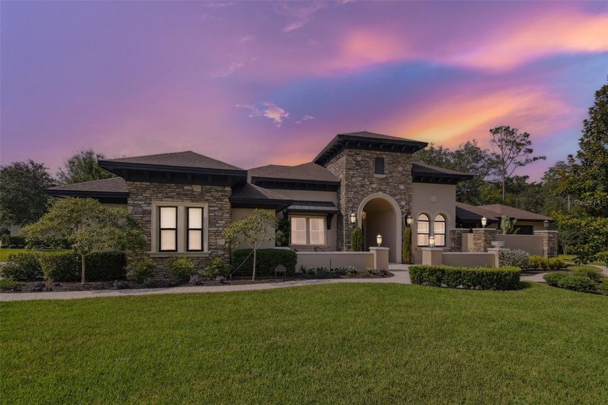 **Active Under Contract Accepting Back up Offers. Welcome to your exquisite dream home! This stunning residence from the expertly crafted collection by Adobe Homes has 5 bedrooms, 3.5 bathrooms, abundant living space, a seamless open-concept floor plan, and striking architectural elements that are bound to leave you in awe. The main living areas are adorned with wide plank hardwood flooring. With an oversized side entry 3-car garage and a resort-style pool surrounded by travertine decking, this residence provides the perfect retreat from the demands of modern life. Nestled within the coveted and gated Pine Cove Estates of Odessa, FL, this residence is situated on a 2.47-acre lot, offering picturesque views of a charming pond. The grand entry with double doors and front foyer beckons you into the formal living/dining room, adorned with 16-foot ceilings, crown molding throughout, exposed beam work, a custom stone fireplace, hanging chandeliers, and captivating floor-to-ceiling glass windows looking out to the pool. You'll be captivated by the Chef’s worthy Gourmet kitchen with a striking island, ample counter space, featuring 42" custom cabinetry with crown molding, soft-close drawers, a custom range hood, a new dishwasher, and a 4-burner gas stove cooktop with a griddle! Additional kitchen highlights include granite countertops, a farmhouse sink, a walk-in pantry, and high-end stainless-steel appliances. The expansive Primary Suite features tray ceilings, wood beams, and generously sized his and her walk-in closets. The primary bedroom features motorized blackout shades, allowing for personalized light control and privacy. The primary ensuite is adorned with dual vanities, granite countertops, and tile wall treatments. Experience ultimate comfort with a large spa-like shower and a freestanding garden tub, creating a perfect oasis for relaxation and rejuvenation amidst a private garden setting. Enter a breathtaking resort-style oasis, showcasing the captivating pool area adorned with a gracefully draped pergola over the spa. Through the panoramic screen enclosure, enjoy serene and unobstructed views of the tranquil backyard and picturesque pond. Take a dip in the crystal-clear, HEATED saltwater pool equipped with an energy-efficient heat pump enabling year around heating, luxuriate in the indulgent waterfall spa, or gather around the inviting fire pit, creating cherished moments of relaxation and enjoyment. Every room in this remarkable home has been thoughtfully designed with expansive glass and windows, providing breathtaking views of the inviting pool and backyard entertaining area. Immerse yourself in the beauty of the surroundings as you move effortlessly throughout the house, enjoying the seamless connection between indoor and outdoor living. The large property boasts a range of outdoor recreational opportunities, including a lighted basketball court, a shuffleboard court, and tetherball, providing endless possibilities for active enjoyment. Water is included in the HOA Fee helping to significantly reduce utility costs for this home. This home also has a detached workshop spanning 379 square feet, fully equipped with HVAC and plumbing. This adaptable area has the potential to transform into a home office, yoga or workout studio, workshop, or mother-in-law suite. BONUS! Custom closet and pantry designed to buyer’s specifications. Move-in ready!