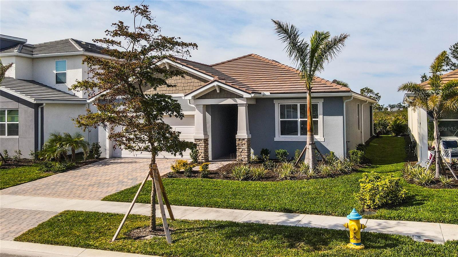 Welcome to this better than new home within Wellen Park’s gated Sunstone community. This beautifully designed residence features an open-concept floor plan with 3-bedroom, 2-bathroom plus den/office; spans 2,005 square feet of beautifully designed living space and was constructed in 2023. Tall ceilings and abundant natural light create a bright and airy ambiance throughout the home.
Better than new means the home has been through the builder warranty “process”. This process can be quite inconvenient and frustrating and can take up to a year or more to complete. All the fit and finish items left over from every new build home are done. Additionally, many items NOT included in a new build are already here. Including:
1) screened in lanai
2) window treatments
3) light fixtures both pre-wired and vanity lights
4) 6 ceiling fans
5) washer and dryer
6) custom master closet system
7) cabinetry in laundry room
This home has high ceilings, fresh neutral paint, seamless wood look tile flooring throughout the great room that flows to the large lanai make this home ideal for both entertaining and everyday living. The spacious kitchen s sure to delight featuring expansive quartz countertops, a large island, tile backsplash, and 42” cabinetry offering ample storage and many counters/cabinets. The two additional bedrooms are generously sized, ensuring guests are comfortable and feel right at home. You will be sure to enjoy the private screened in lanai overlooking the Florida natural landscape.
The Sunstone Community offers various amenities such as multiple gathering areas, a resort-style pool with a beach entry, lap swimming area, hot tub, fire pit, pickleball courts, bocce, dog park, large fitness center, and a Lifestyle Director who coordinates resident activities. Explore Downtown Wellen Park on foot, bike, or golf cart featuring abundant restaurants, shops, and live entertainment. The Cool Today Park hosts Atlanta Braves spring training games and events, while the Venice and Manasota beaches are just a short drive away.
Enjoy a variety of outdoor activities including golfing, boating, kayaking, paddle boarding, fishing and close to historic downtown Venice with its shops, restaurants, and theaters. Wellen Park hosts educational facilities including Wellen Park College Prep (K-8 Charter School), with Wellen Park High School opening soon, and the State College of Florida. Community services include a firehouse and HCA Florida Wellen Park Emergency Center. Don’t miss out on this opportunity to start living the Florida lifestyle you so richly deserve.