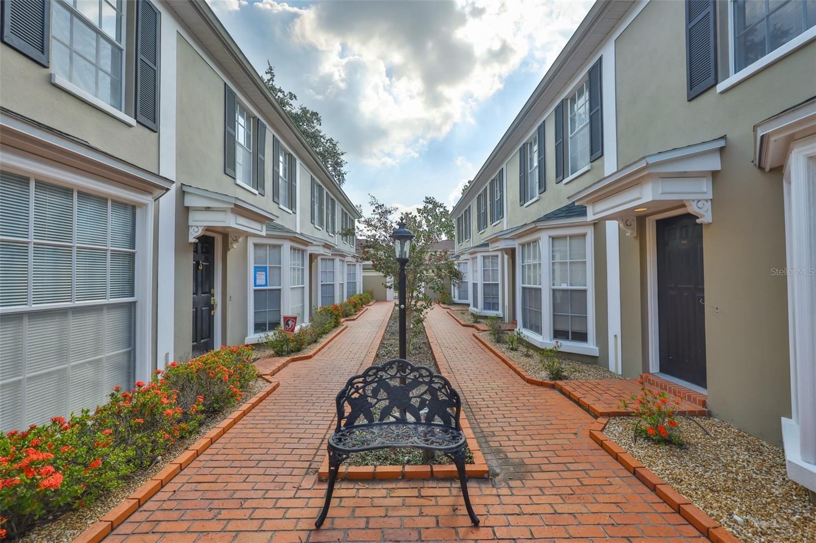 South Tampa living meets coastal charm! This home is the perfect balance of charm, convenience, and lifestyle. With its inviting beach vibe, spacious layout, and unbeatable location, it offers a unique opportunity to live minutes from Tampa's most desirable destinations. Whether you're a first-time homebuyer, a young family that dreams to walk their kids to one of the best Mitchell Elementary schools, a young professional, or looking for a stylish investment property, this townhome-style residence checks all the boxes: modern living, walkability, and a low-maintenance lifestyle. Step inside and enjoy the bright and airy open living room that flows into a chef-inspired kitchen with generous counter space, making it the perfect gathering spot where cooking, conversation and connection come together. The kitchen opens effortlessly through sliding doors to a paved, cozy patio, creating a perfect indoor-outdoor flow for your intimate morning coffee, relaxing or evening gatherings. Upstairs, you'll find two large bedrooms with vaulted ceilings, connected by a spacious Jack-and-Jill bathroom with dual vanities, offering both comfort and convenience. Covered parking in the rear with an assigned spot for your car is included. Location is everything, and this property delivers! Ideally situated just 5 minutes from Downtown Tampa, the University of Tampa, Armature Works, Hyde Park Village, Water Street, and Bayshore Boulevard, putting you at the center of it all - dining, shopping, nightlife, and outdoor activities. With its modern yet relaxed style and unbeatable location, this property is the perfect place to call home.