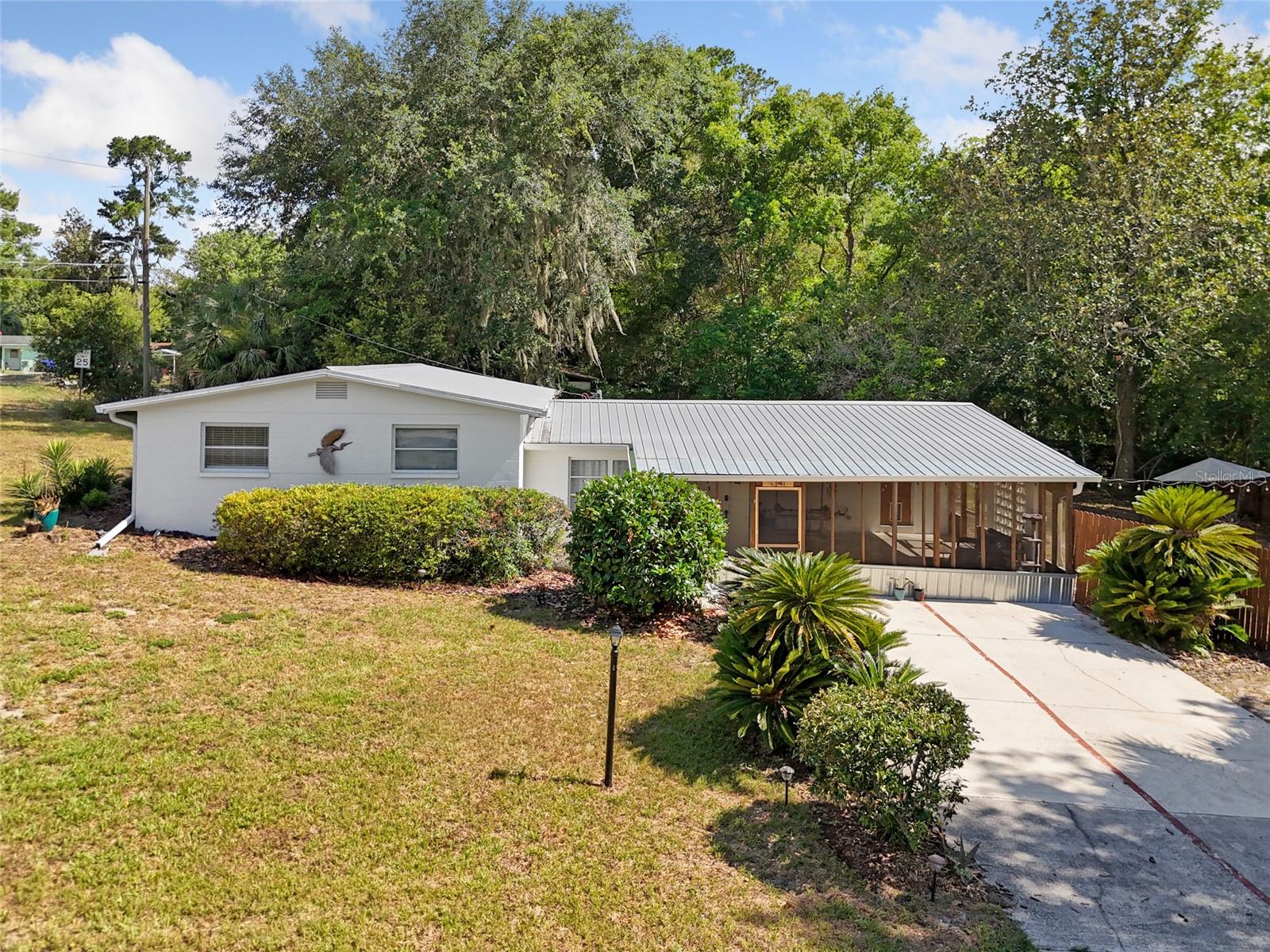 Adorable 4-bedroom, 2-bathroom Concrete Block Home on a HUGE corner lot in Robinson Heights sitting on a private cul-de-sac, bordering the La Chua Trail and steps away from Boulware Springs Park along with Paynes Prairie!!! It won't take long to realize that if you're into nature and wildlife-related activities this property's location is TOP TIER! In addition, This home is built to last forever and boasts the most beautiful and maintenance-free features you can find. Walk into this timelessly strong, durable, and Grande Concrete block home with a Metal Roof and you're immediately welcomed by the stunning Mid-century modern/Modern contemporary hybrid design that is truly a one-of-a-kind masterpiece! Gorgeous Terrazzo, a funky yet functional split-level floor plan, and some old-school charm will have you wanting to take a seat and kick off your shoes in this Idyllic Gainesville retreat. NEW Luxury vinyl plank (2022) AND a NEW rolled roof (2020) on the addition portion of the home installed recently. Brand New Septic and Drain fields in 2021. Electric upgraded from 100amp to 200amp in 2020. Terrazzo restoration and interior/exterior painting in 2020. Close to UF, Sante fe College, VA hospital, Shands, endless Restaurants and shopping plus nightlife.