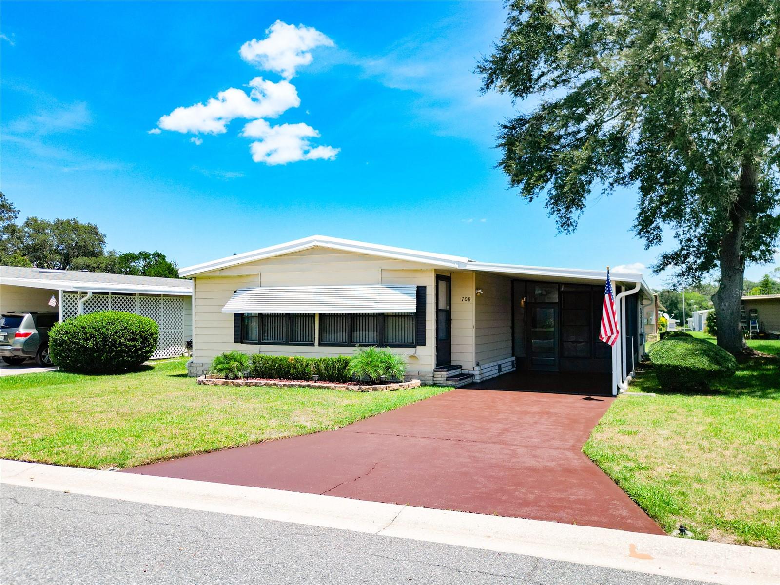 ACTIVE ADULT PARADISE – Discover Your Florida Retirement Dream! Just minutes from The Villages and about an hour to Disney, this immaculate 2-bed, 2-bath manufactured home in the desirable 55+ Coachwood East community offers 1,248 sq ft of updated, single-level living. Features include Luxury Vinyl Wood Planks, Berber carpet, ceramic tile, and no deferred maintenance — clean & truly move-in ready! Enjoy low $50/mo HOA access to a heated pool, fitness center, clubhouse, and pet-friendly, golf-cart-friendly streets. Accessibility is built-in with wide hallways, covered parking, and laundry room. Own your land (no lot rent!) and enjoy proximity to The Villages, medical facilities, shopping, dining, and the Harris Chain of Lakes all designed to keep you active and connected. Whether you're soaking in the sunshine or enjoying the nearby amenities, this home supports the lifestyle you love.