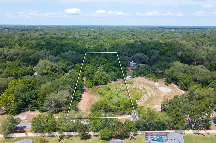 Located just minutes from The Villages, this 2.50 acre parcel offers a great combination of space, location, and readiness.

The property has been cleared of structures and is currently vacant, providing a straightforward path for its next use. Impact fees have already been paid, offering a valuable cost savings moving forward.

A pond sits at the front of the property, adding to the natural setting and overall appeal. There is already a well drilled, electric available and a septic system in place; however, the buyer will need to verify condition and functionality.

Situated in Sumter County, this location offers convenient access to nearby shopping, dining, and everyday amenities while still maintaining a more open, spacious feel.